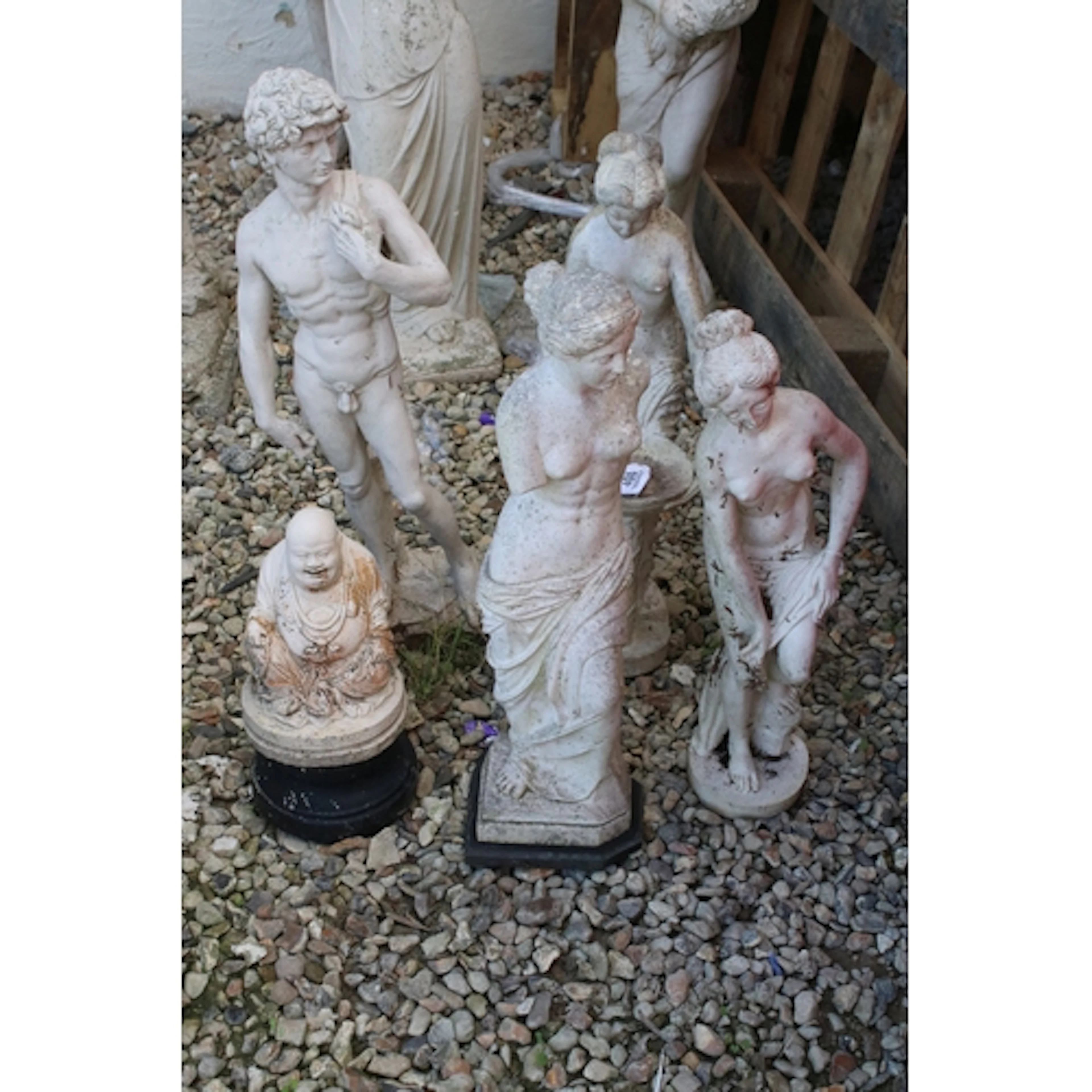 Five reconstituted stone garden statues to include three cla...