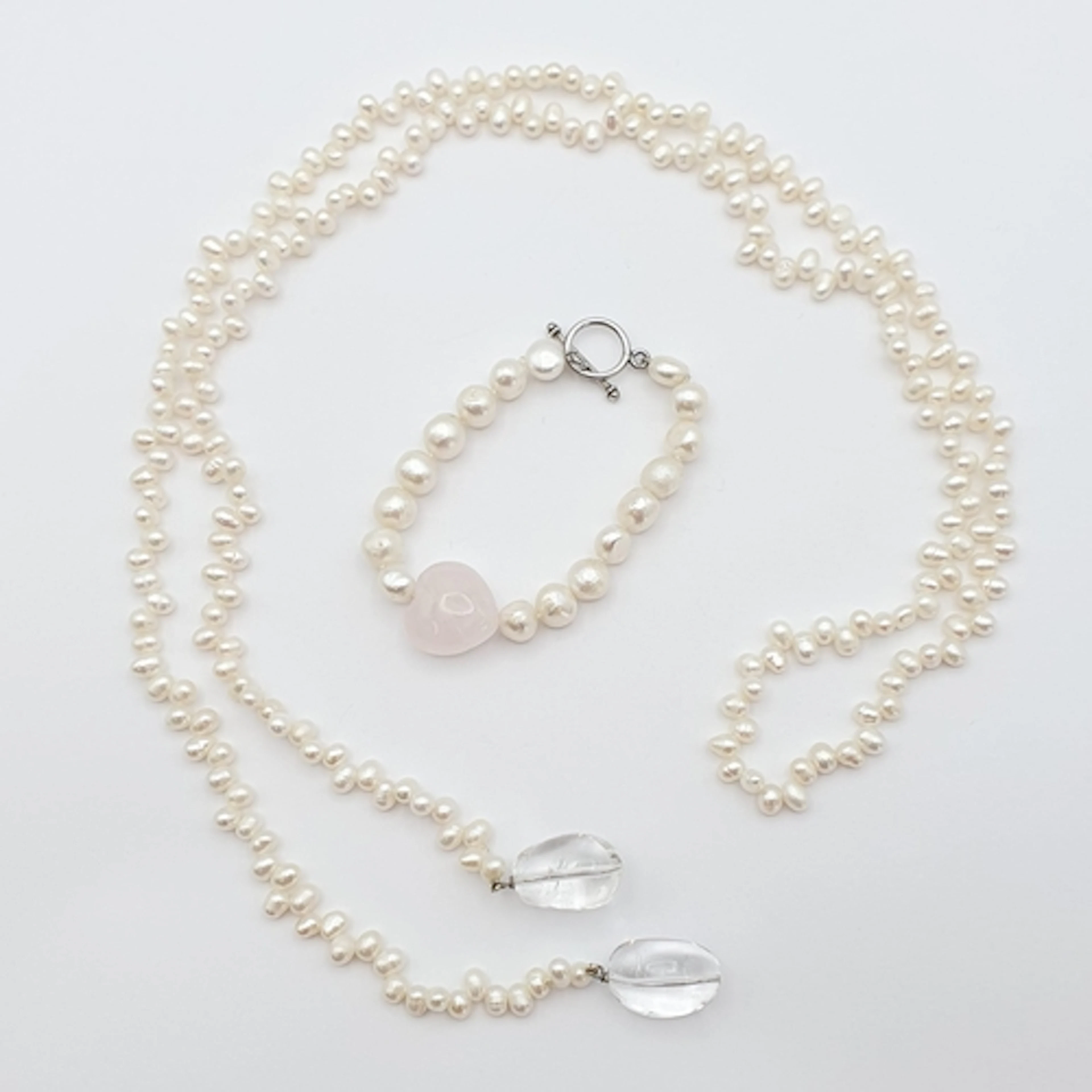 A freshwater Pearl Bracelet with rose quartz heart to its ce...