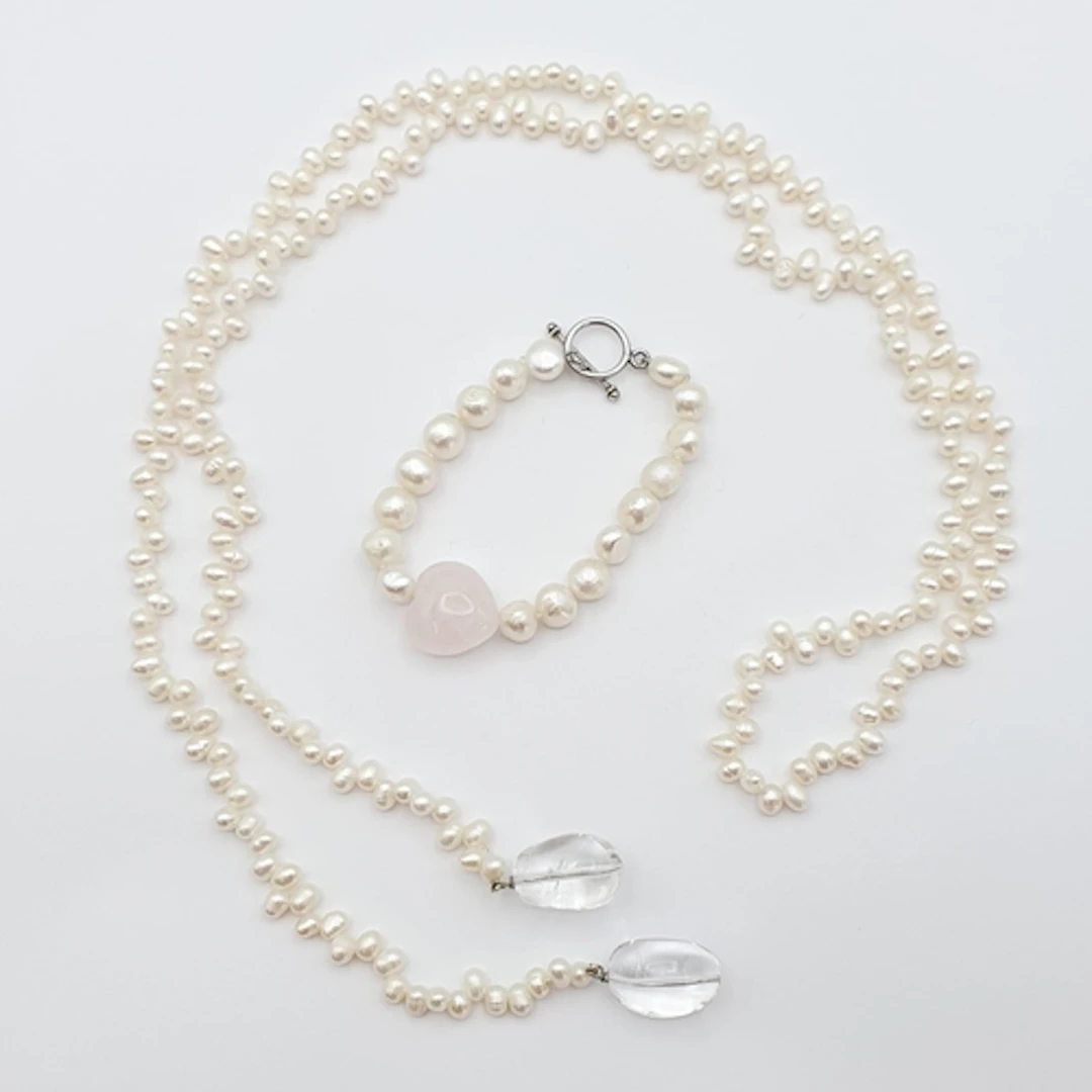 A freshwater Pearl Bracelet with rose quartz heart to its ce...
