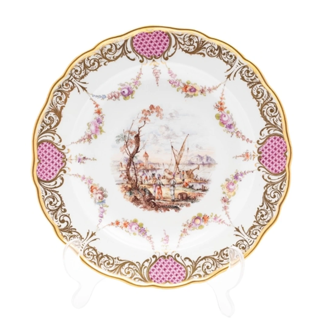 A Meissen porcelain plate painted with a busy harbour scene ...