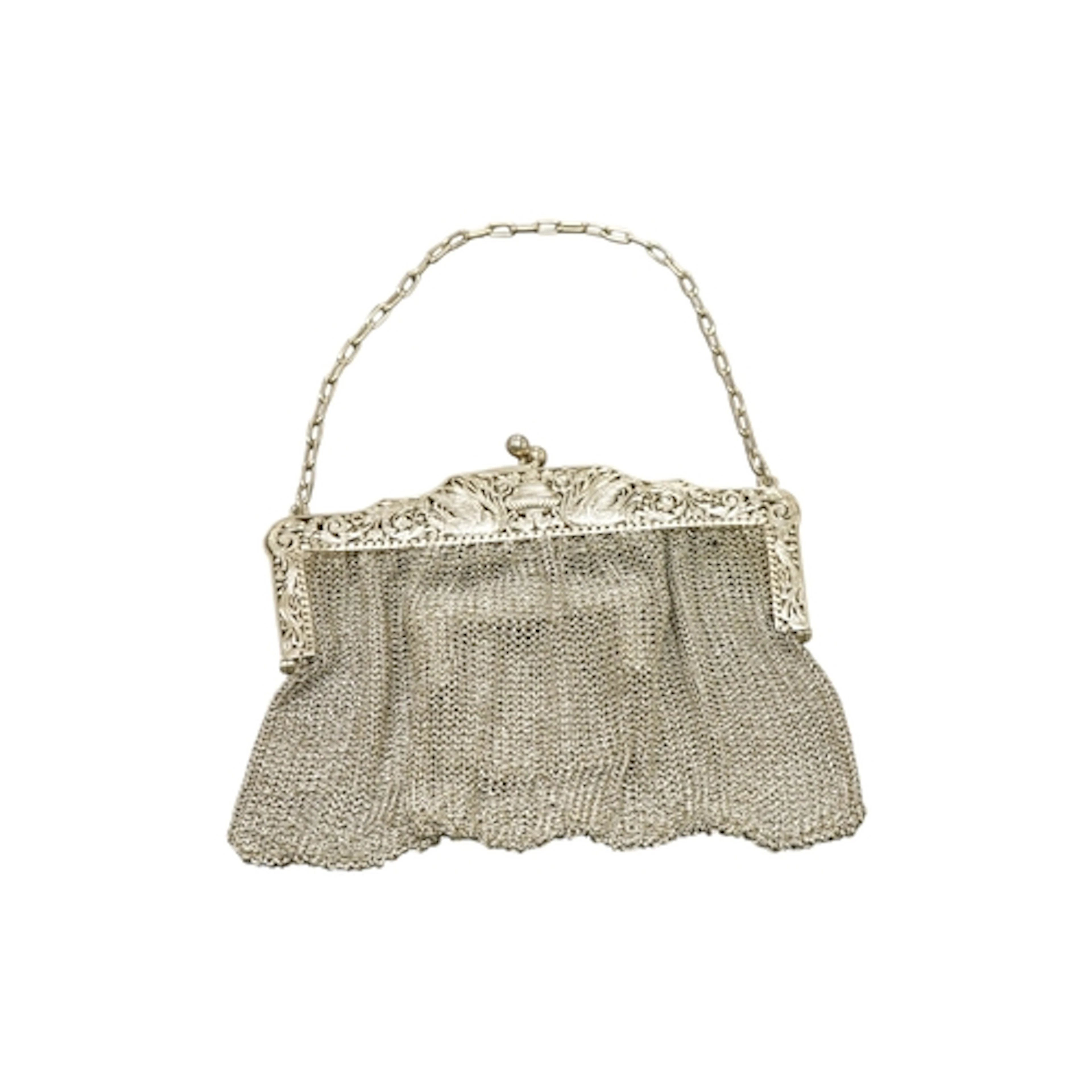 An Edwardian silver mesh evening purse and interior integral...