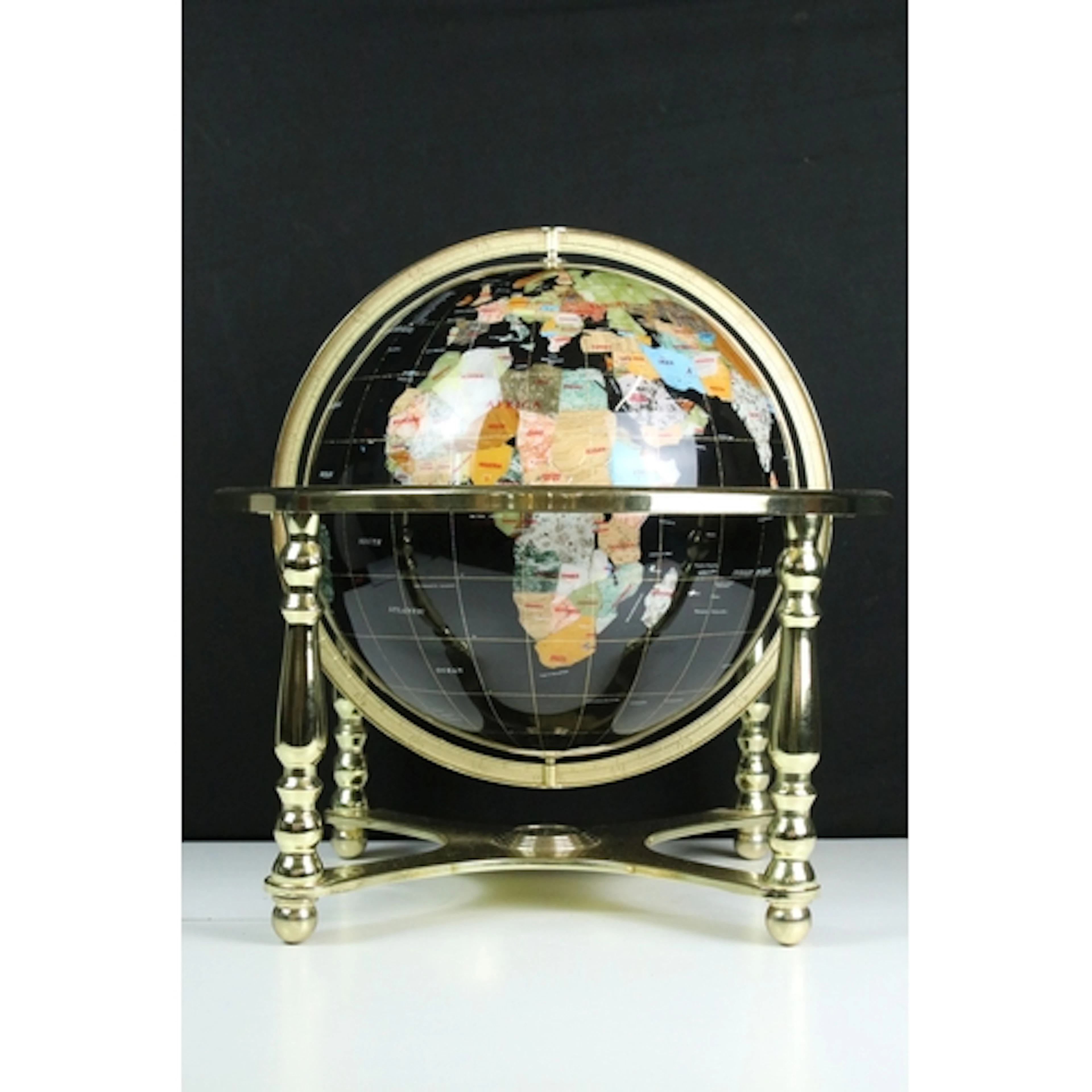 Quartz world globe with central compass mounted on a brass s...