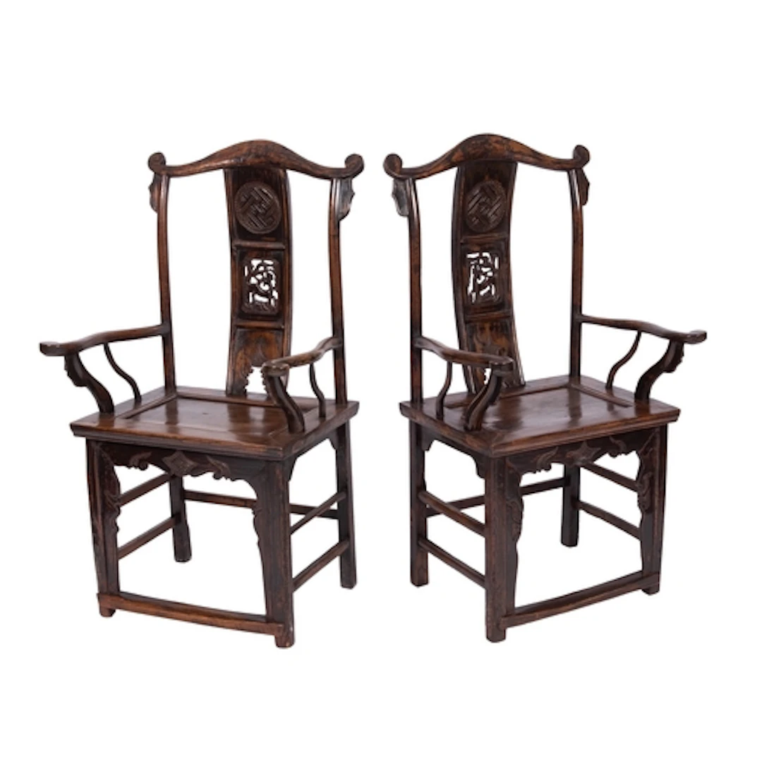 A pair of Chinese yoke-back open armchairs, the shaped backs...