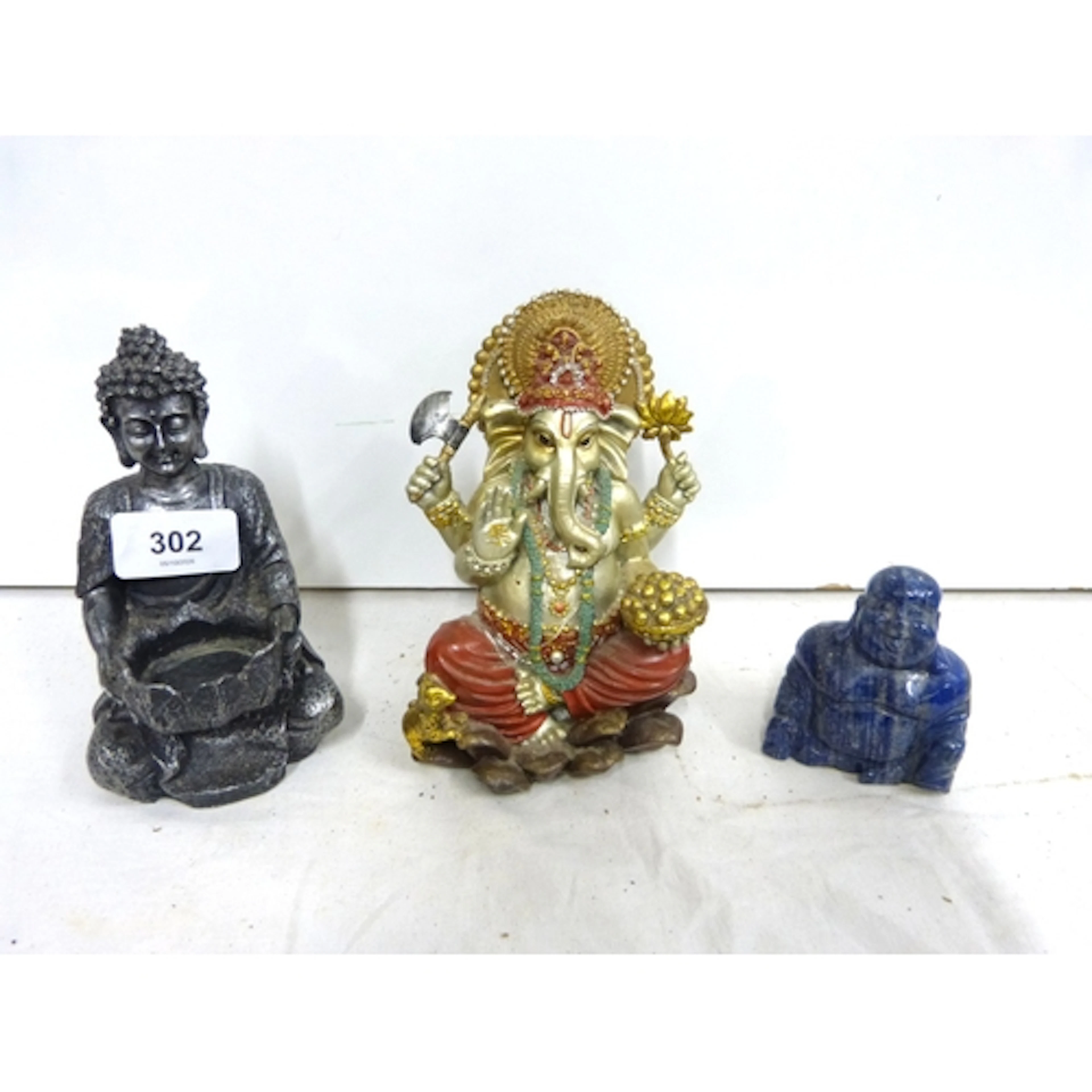 Gnashi figure, Chinese agate Buddha and a resin figure.