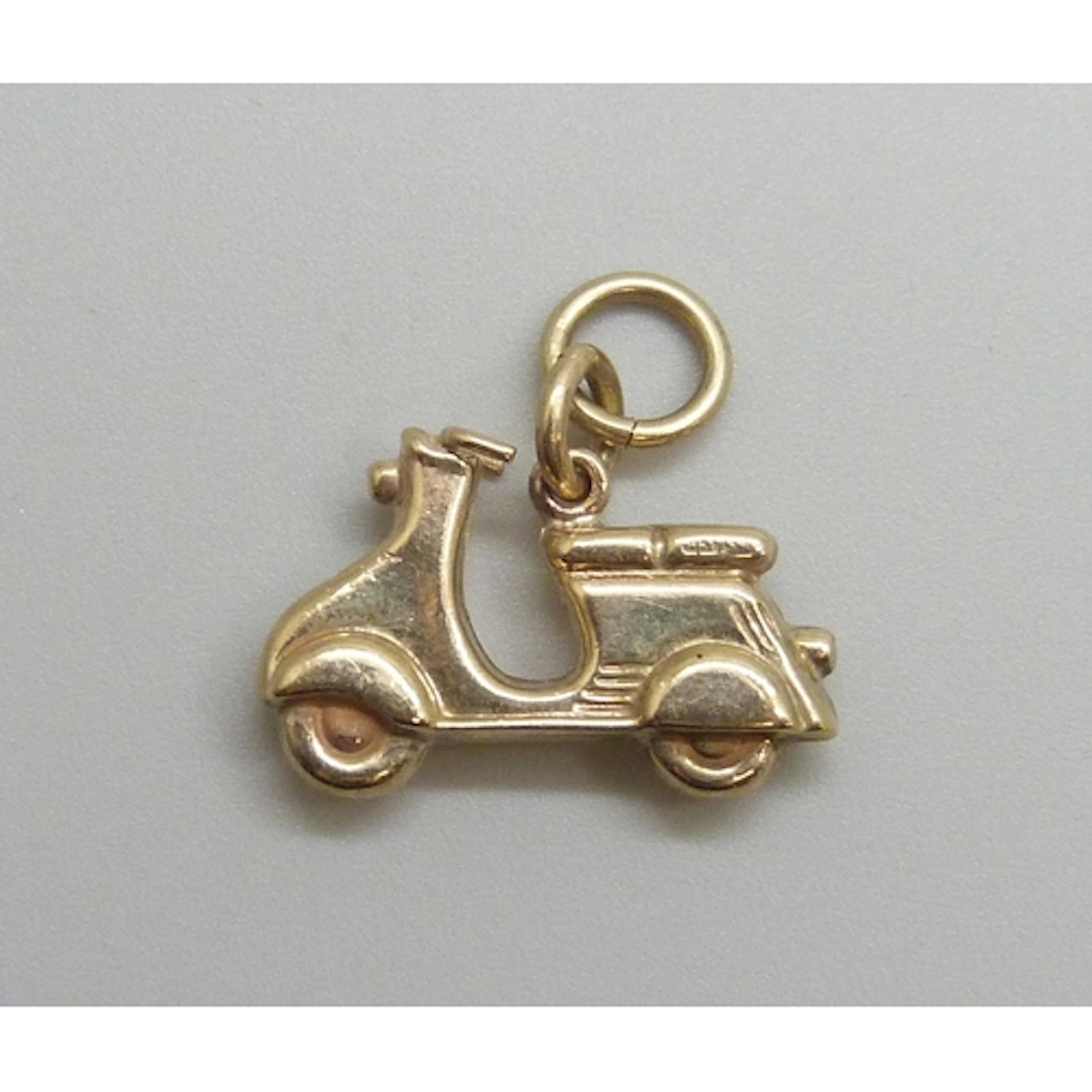 A 9ct gold charm in the form of a scooter or moped, hallmark...
