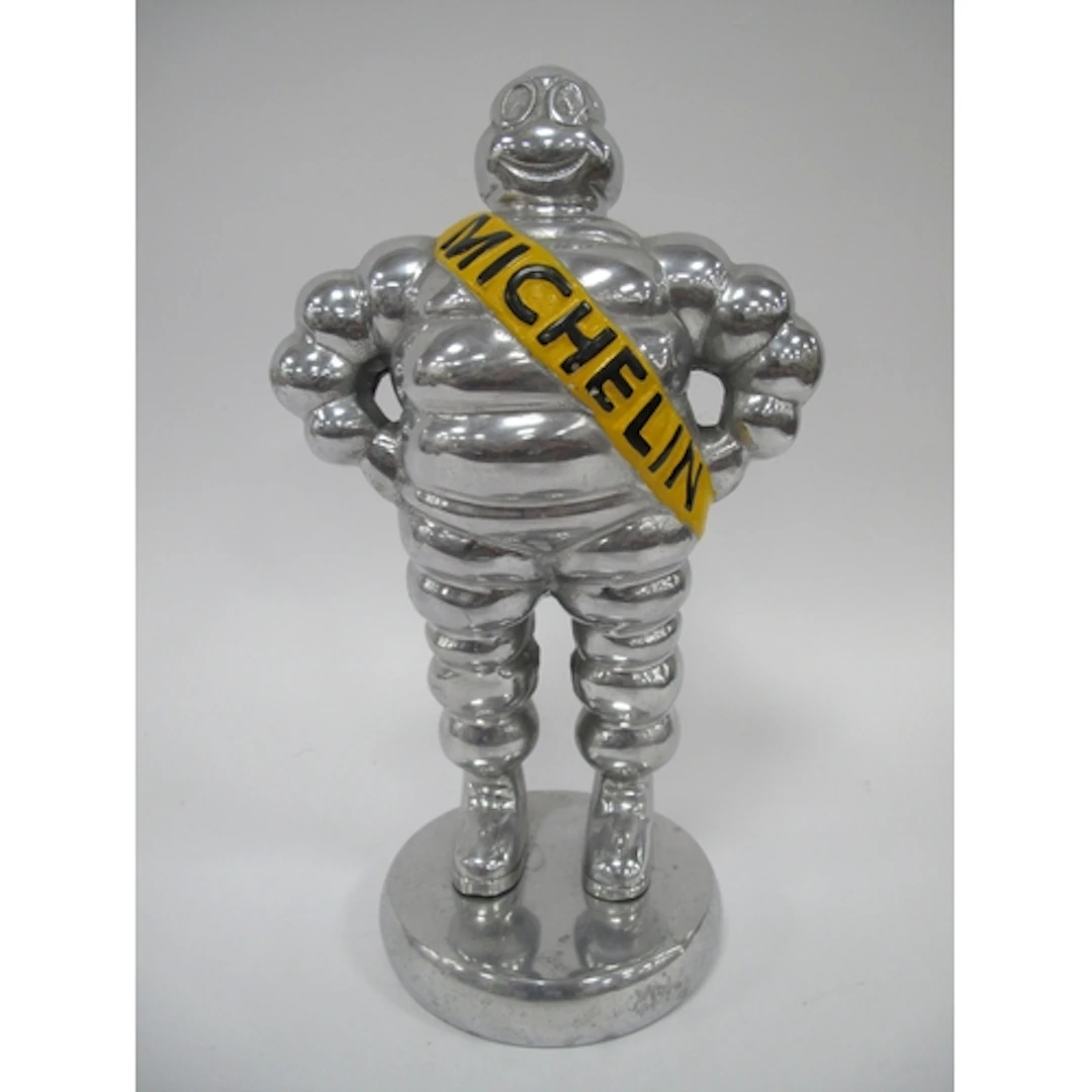 A Chrome Model of the Michelin Man on a circular base, 33cm ...