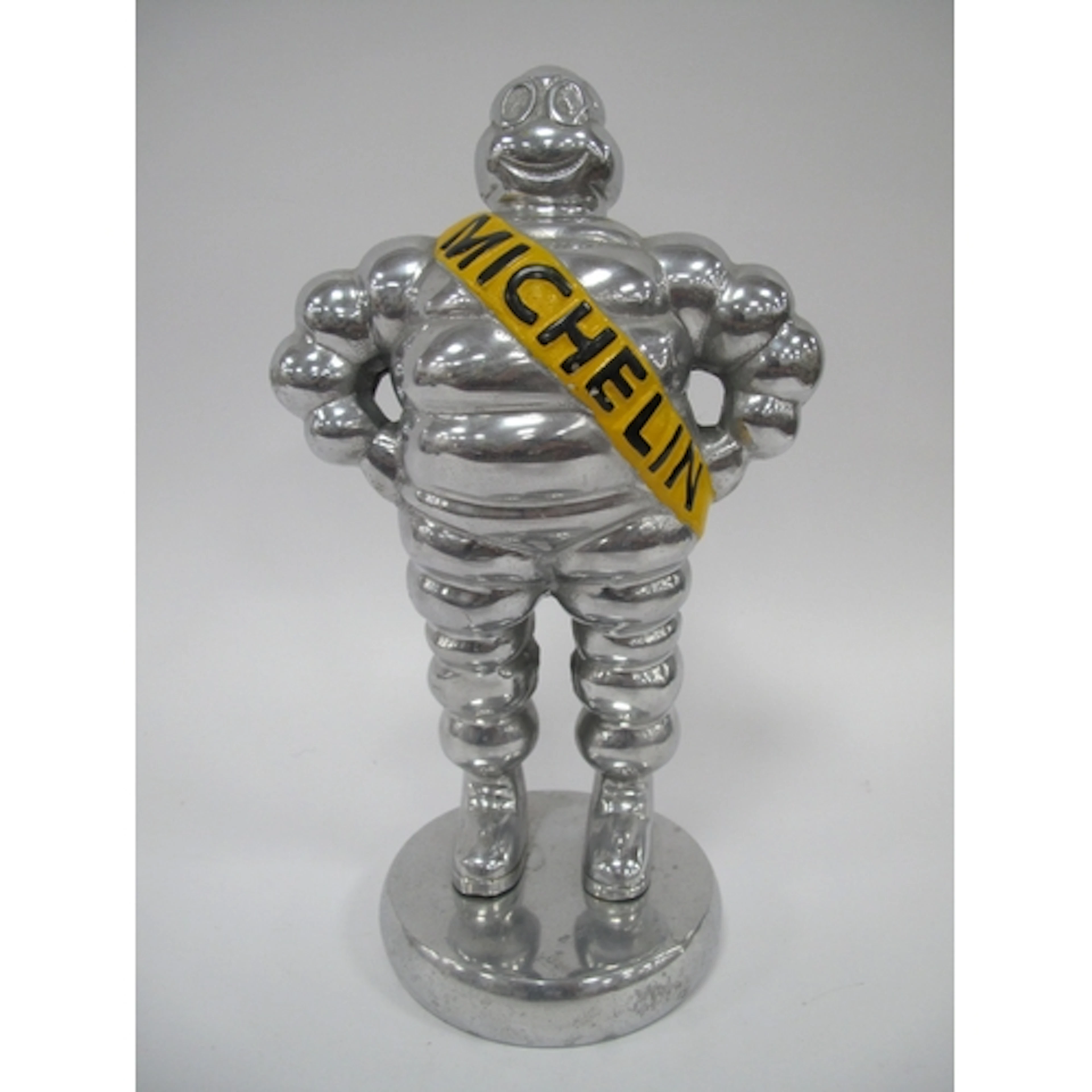 A Chrome Model of the Michelin Man on a circular base, 33cm ...