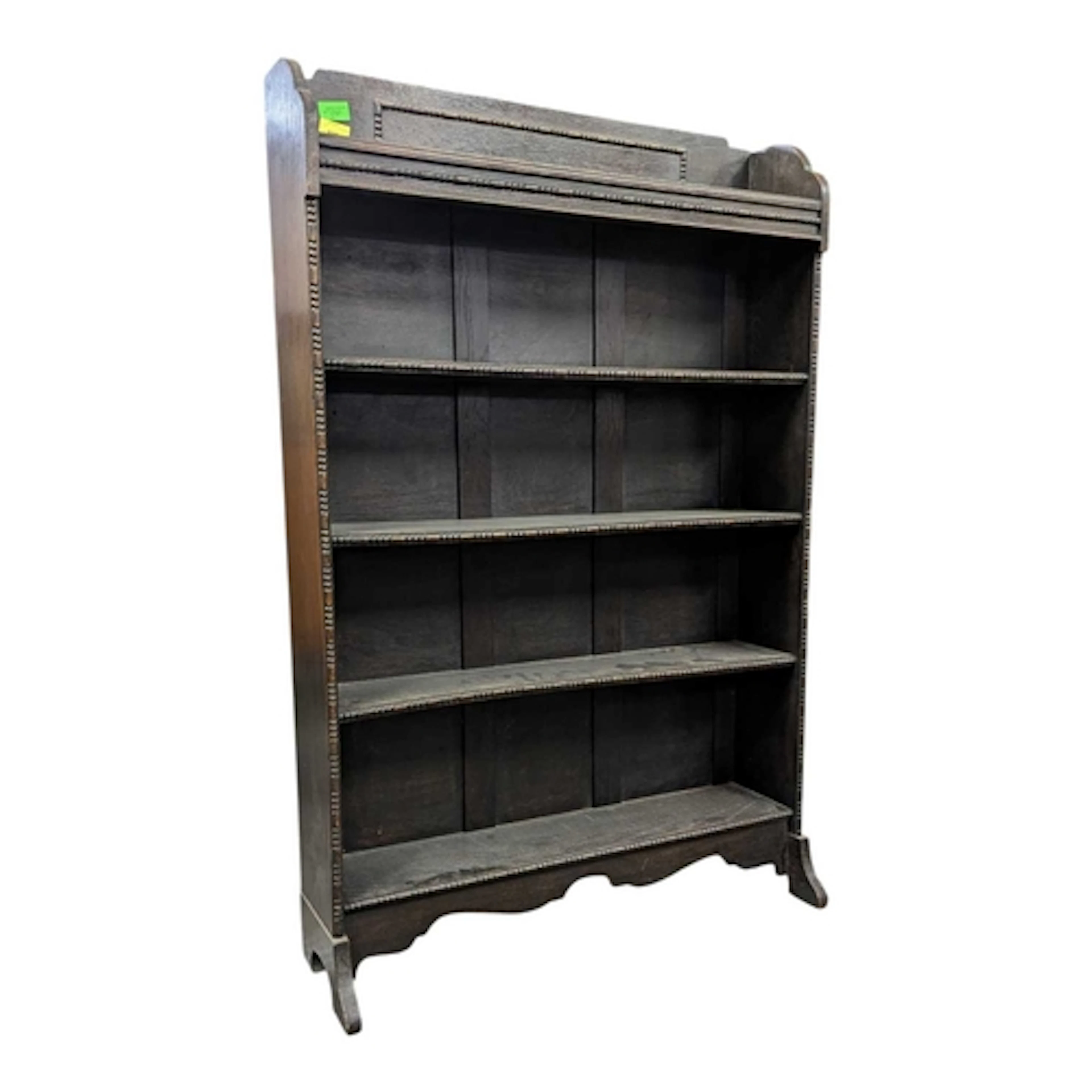An early 20th century oak wood open front bookcase. The book...