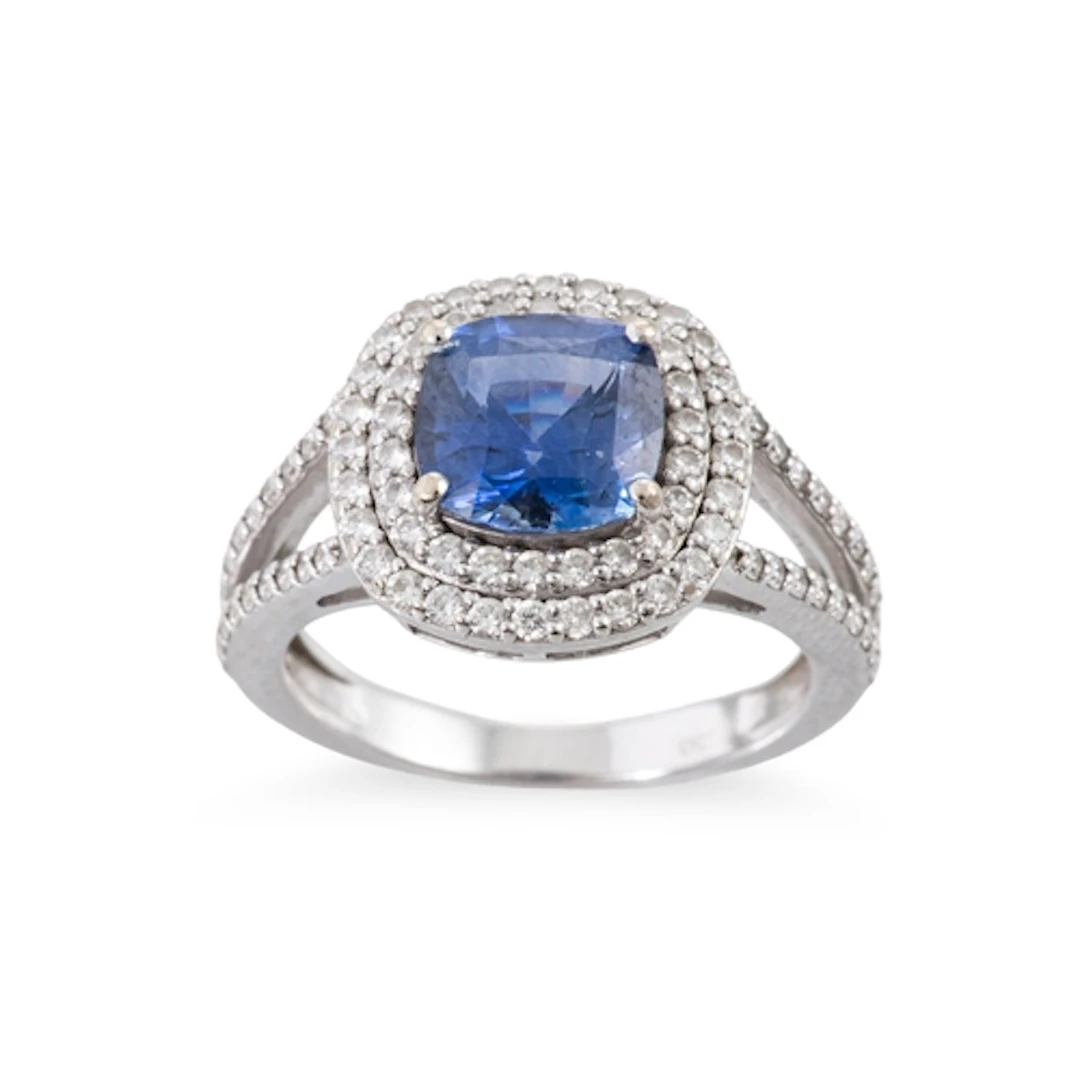 A TANZANITE AND DIAMOND CLUSTER RING, the cushion cut diamon...