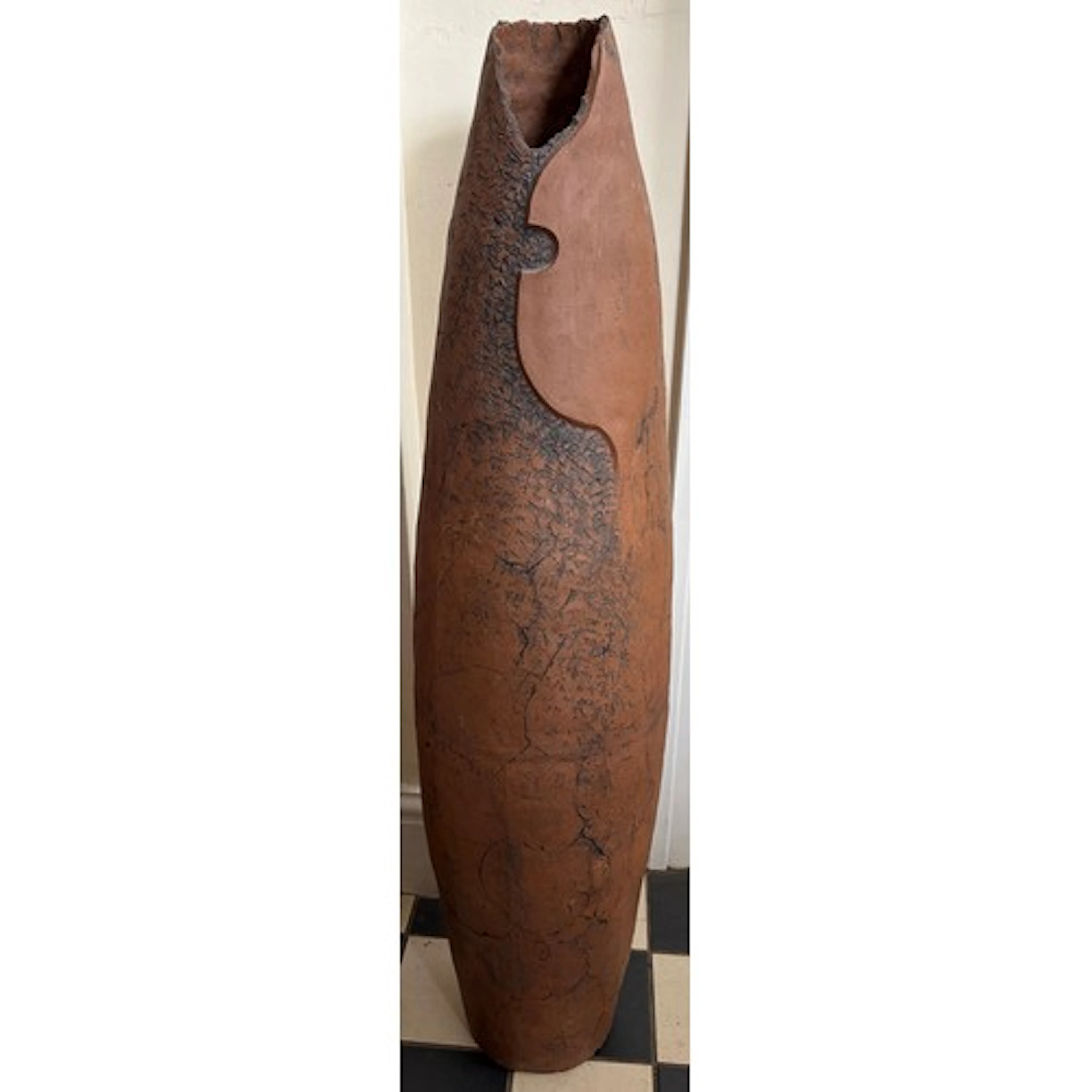 A large textured cigar shaped studio pottery vessel measurin...