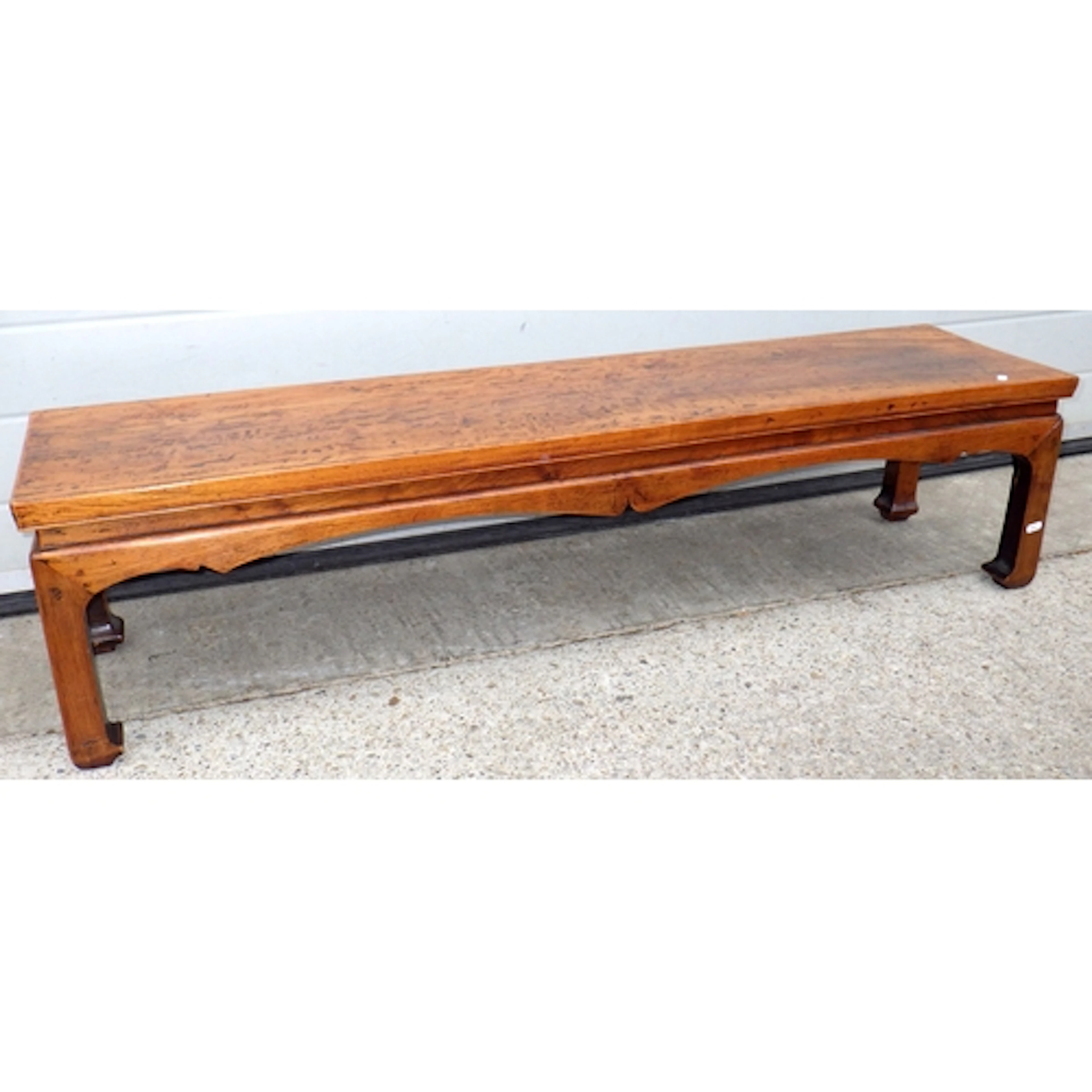 An Oriental long stool, leg repaired, 135cm long (a/f)