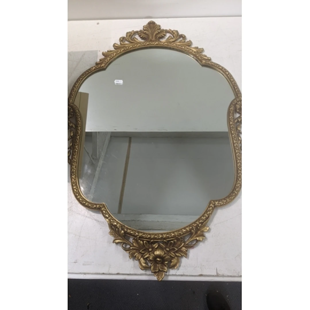 A 20th century reproduction baroque style gilt framed mirror...