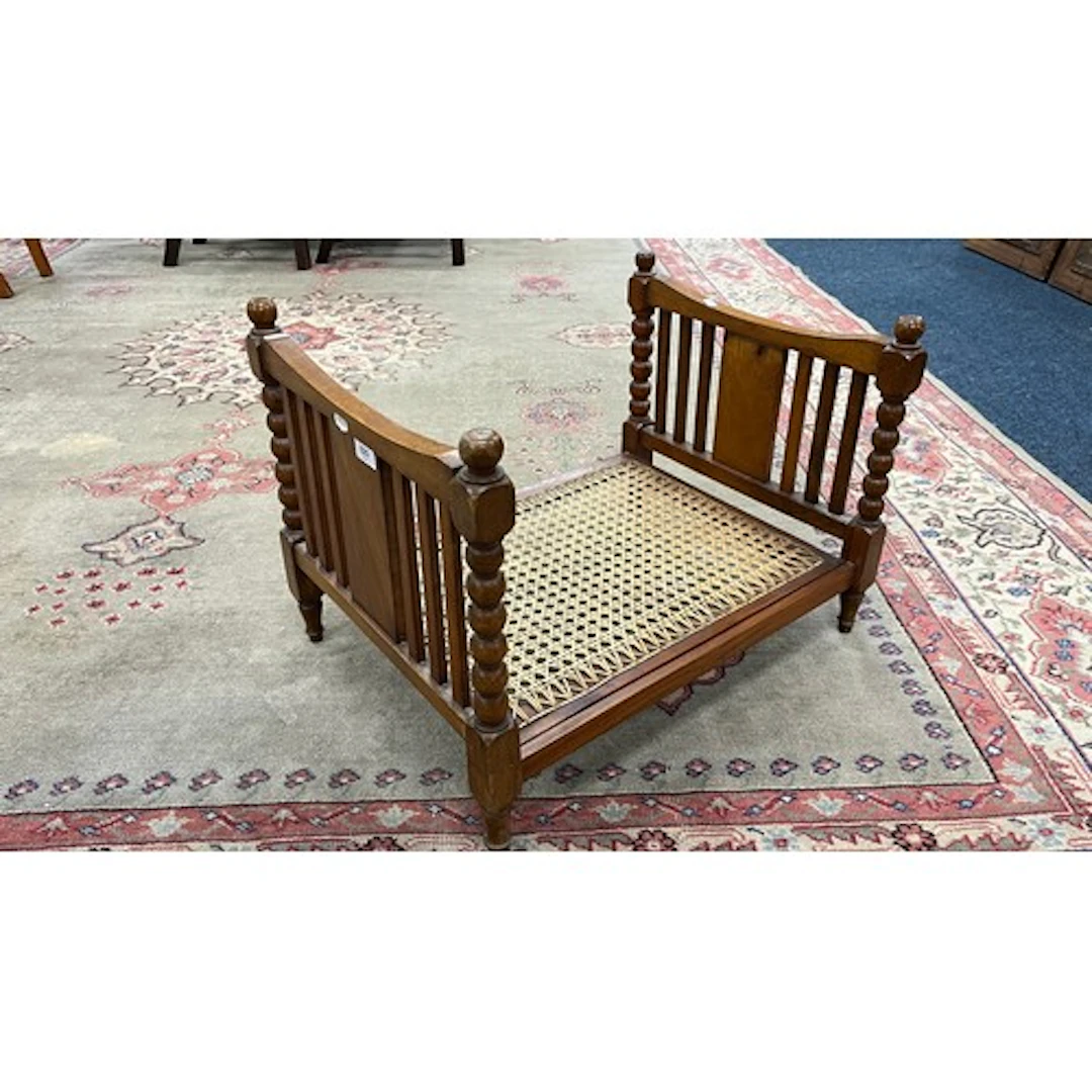 Mahogany miniature bed frame with caned base and turned spin...