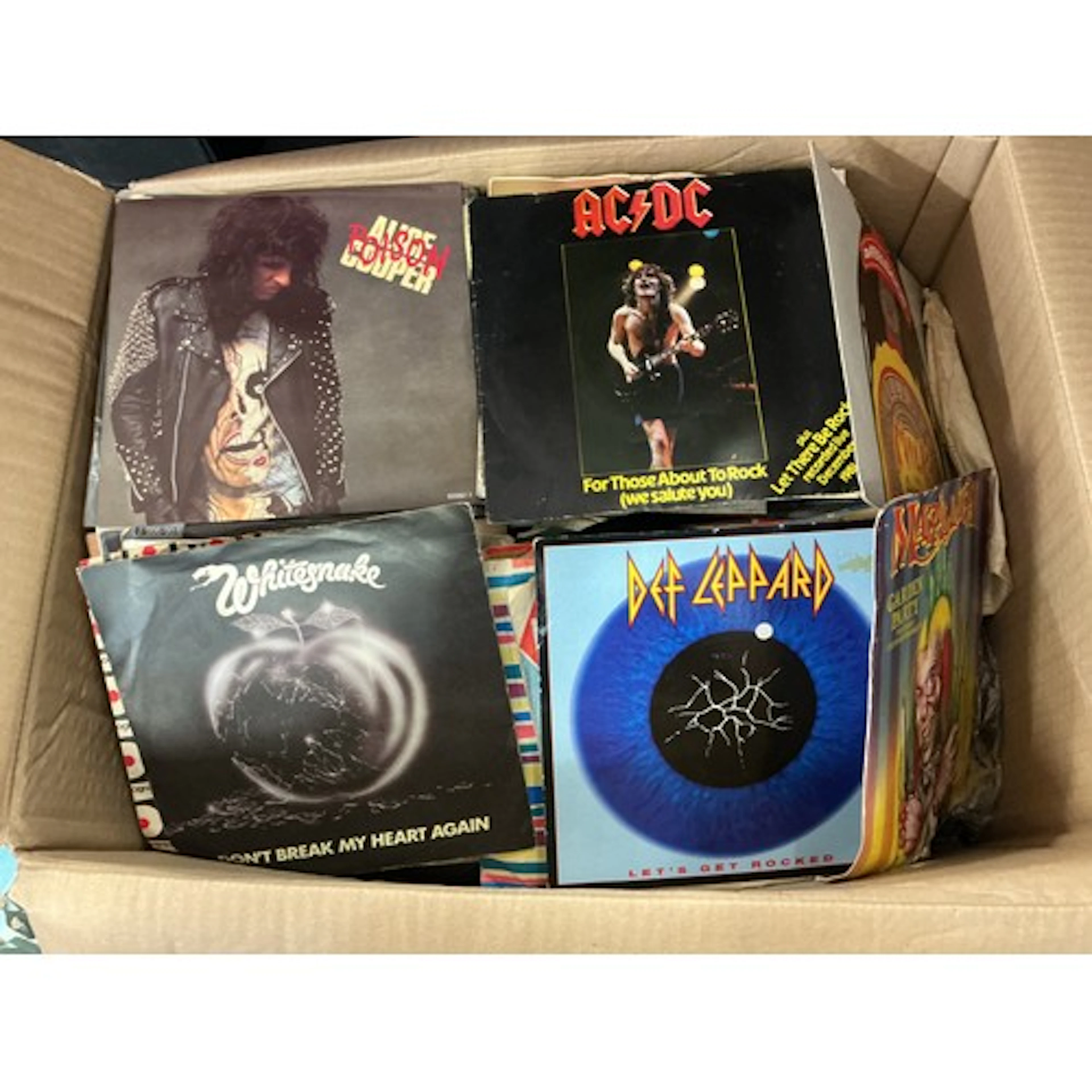 Two boxes of 7” singles and EPs by various artists including...