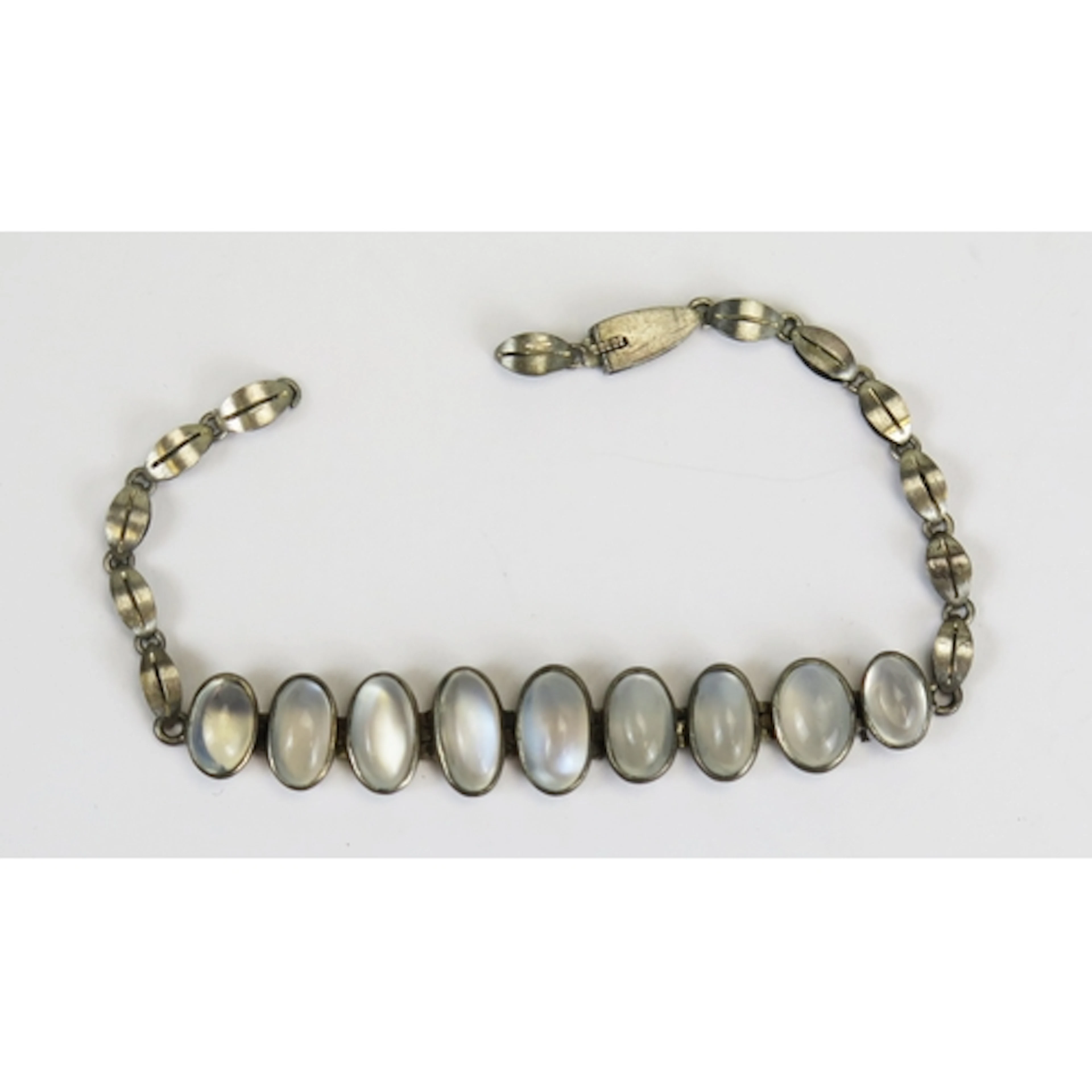A moonstone bracelet in a white metal setting, 17cm