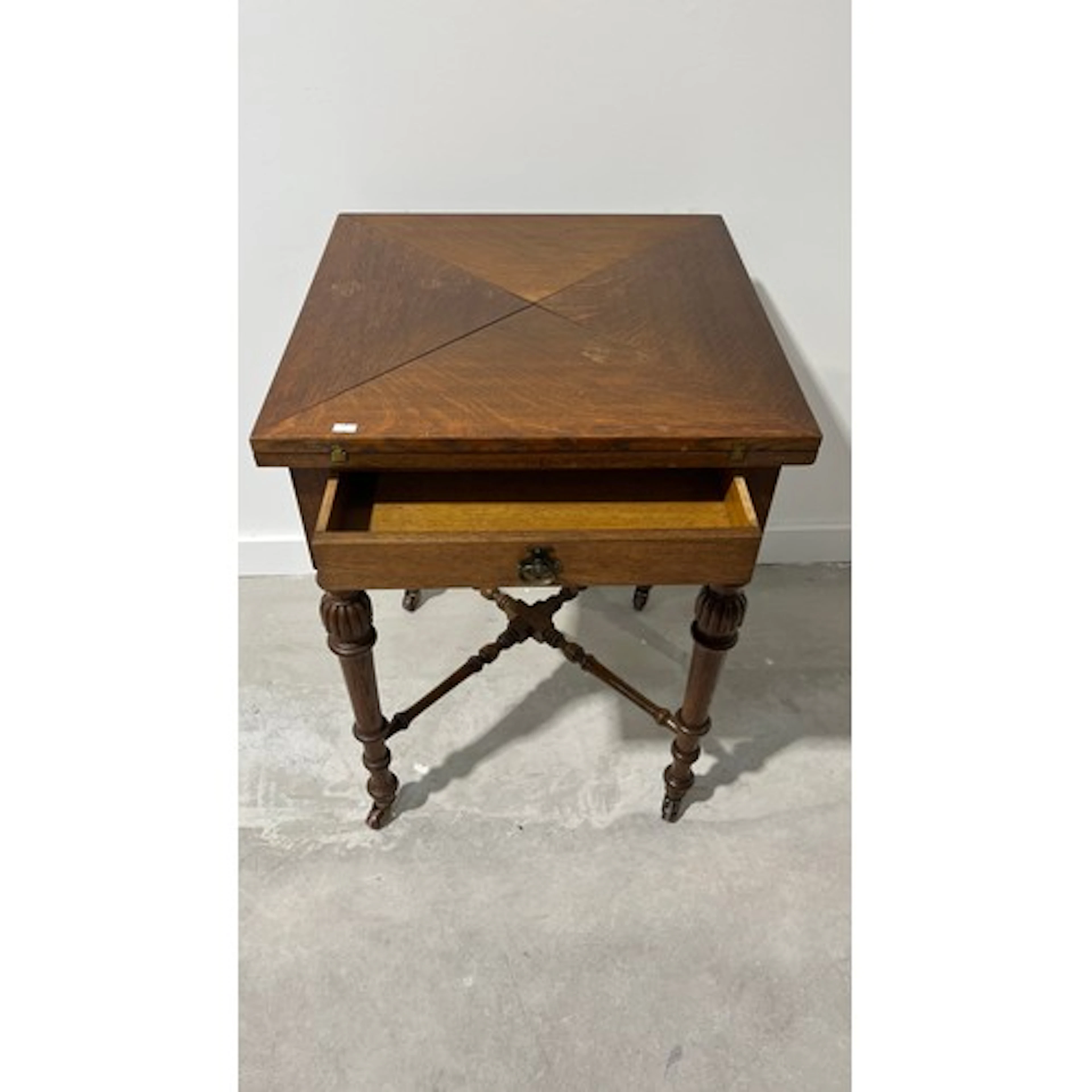 Envelope card table, raised on baluster turned legs terminat...