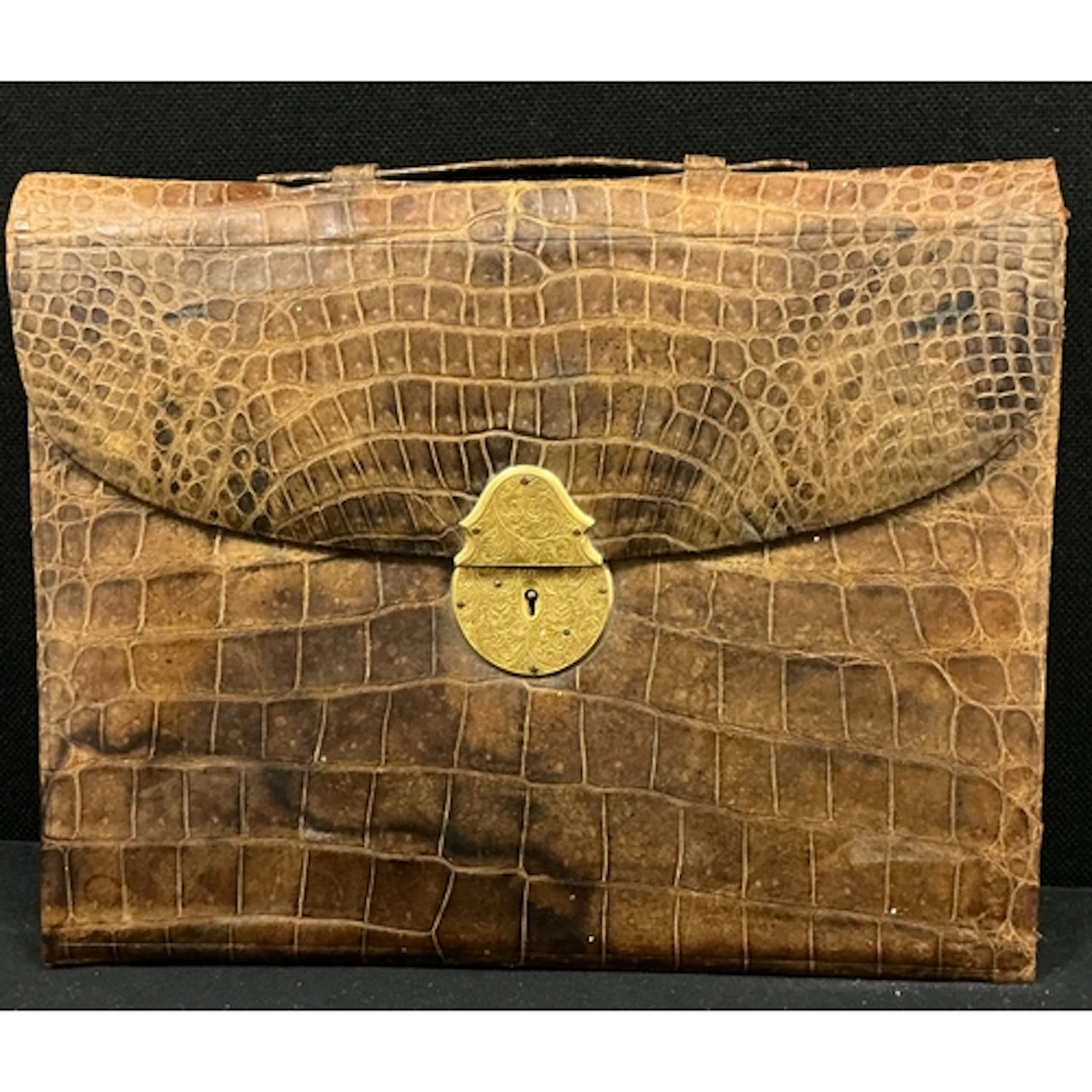 A Victorian crocodile leather writing case, interior includi...