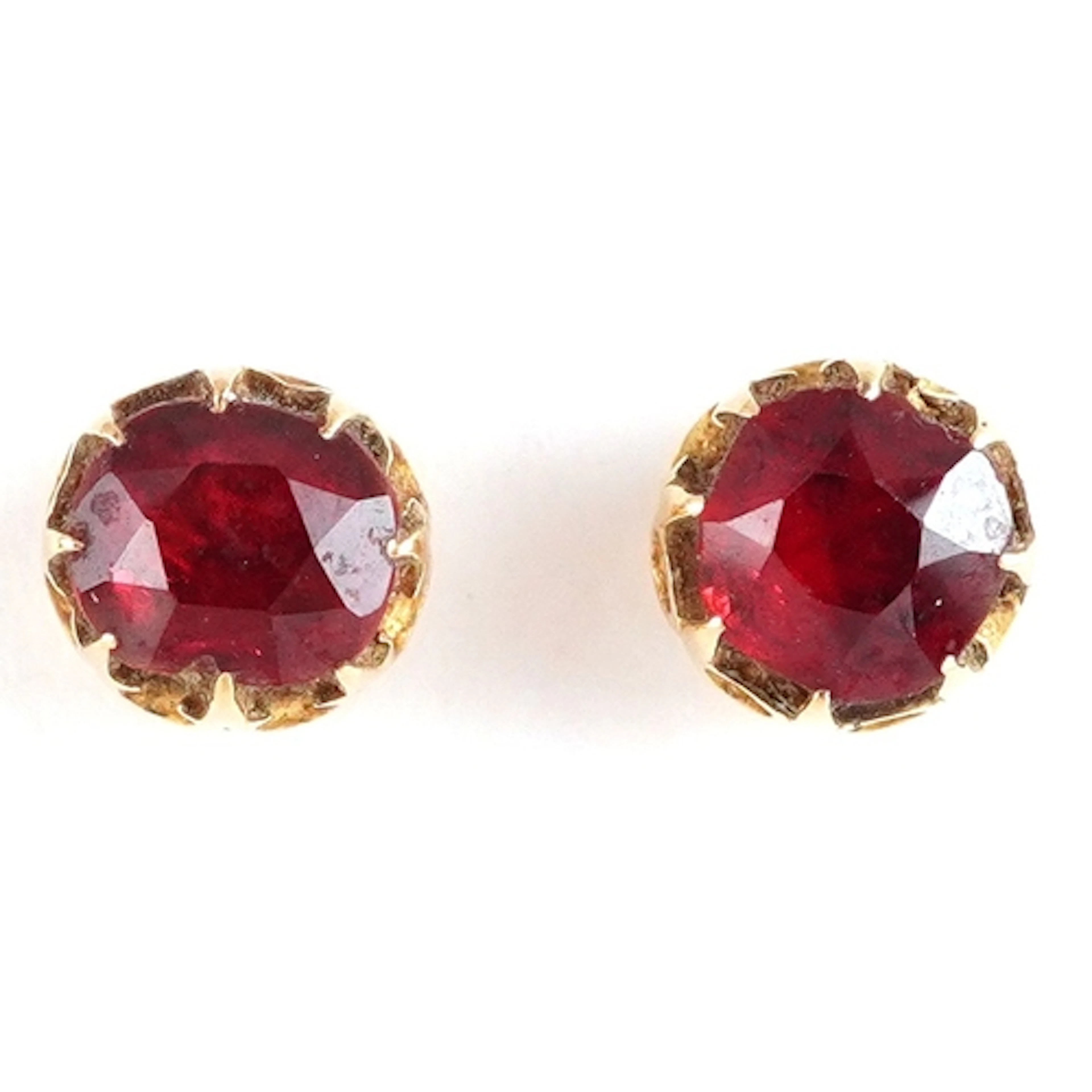 Pair of unmarked gold red stone stud earrings, 5.9mm in diam...