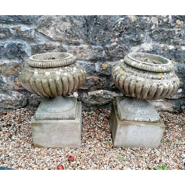 Pair of fluted urns on square pedestals - 40cm x 63cm high