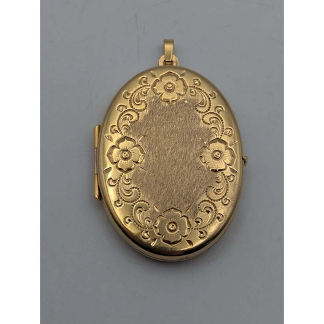 A 9ct yellow gold oval shaped locket, having floral decorati...
