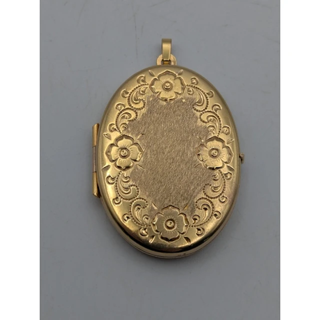 A 9ct yellow gold oval shaped locket, having floral decorati...