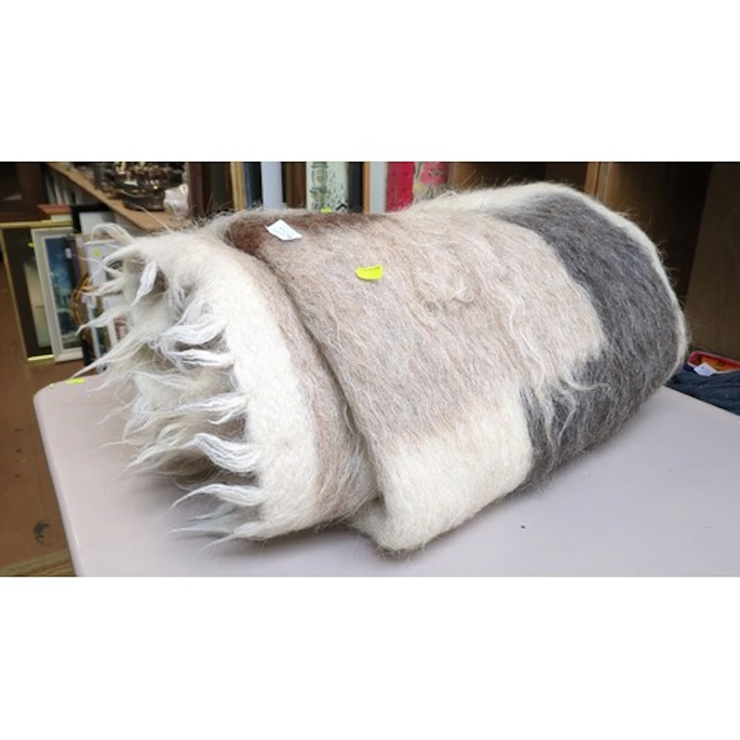 A brushed-fibre throw with broad cream, brown and charcoal s...