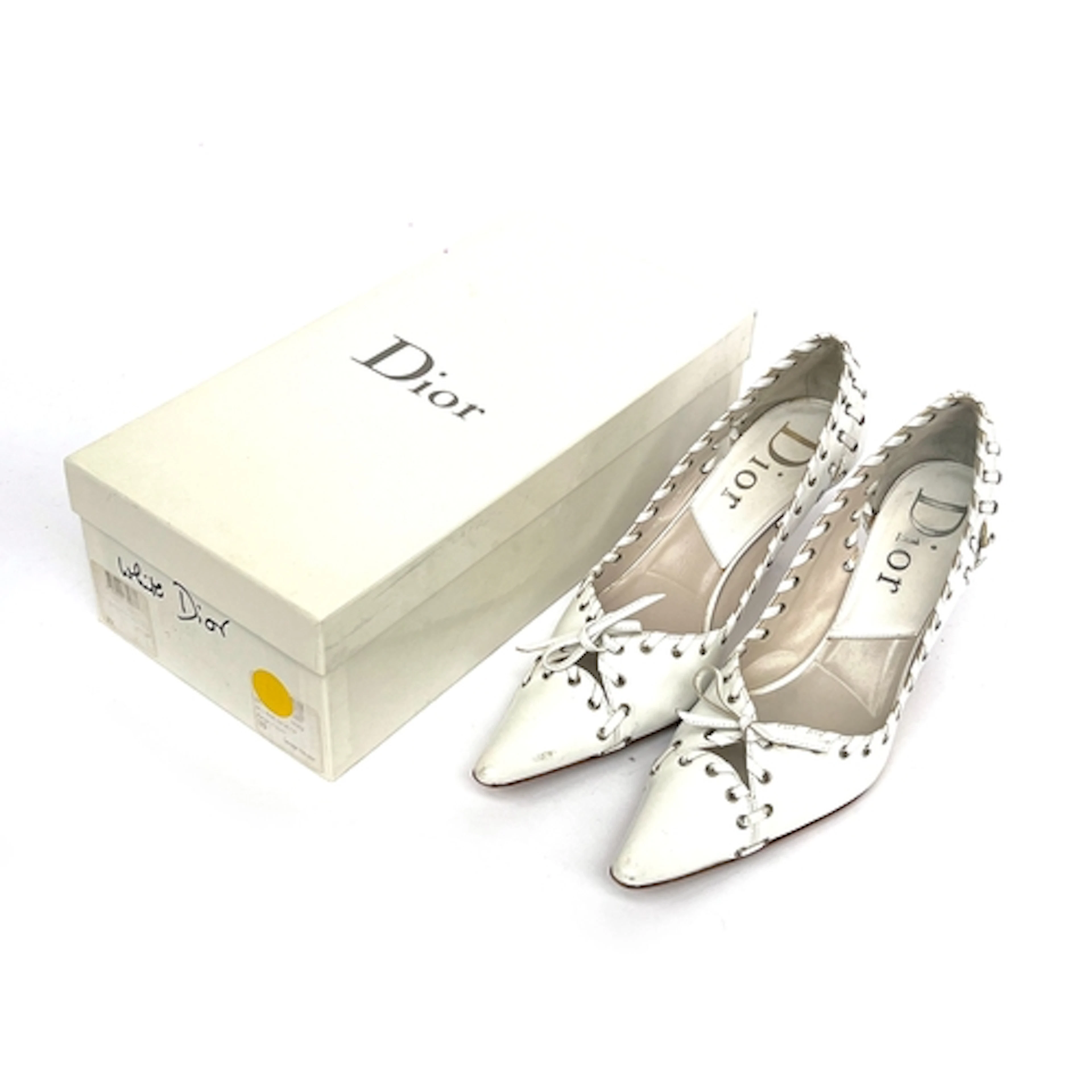 A pair of Dior by Galliano white leather heels with laced gr...