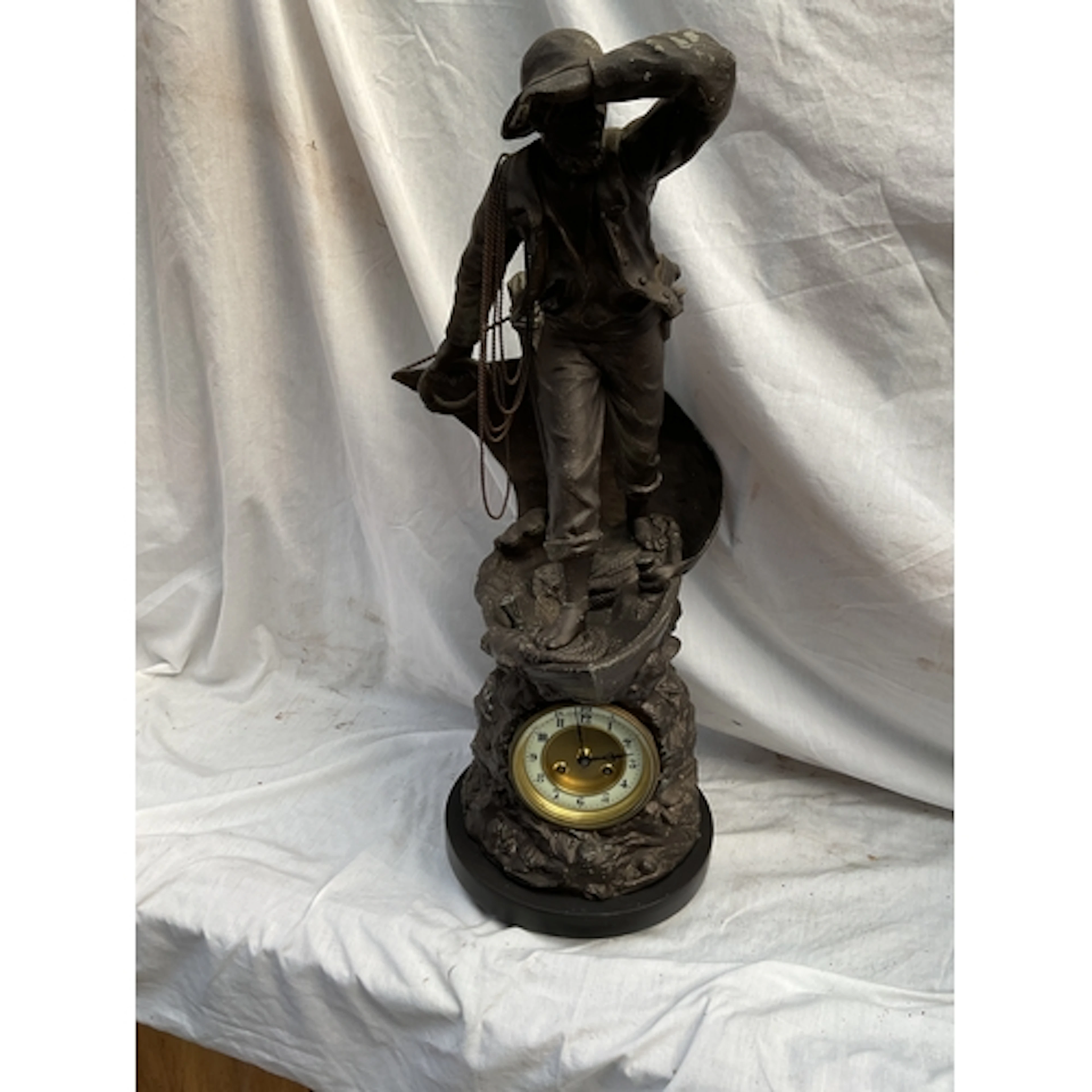 19th C large spelter clock of a mariner on a boat,with a bas...