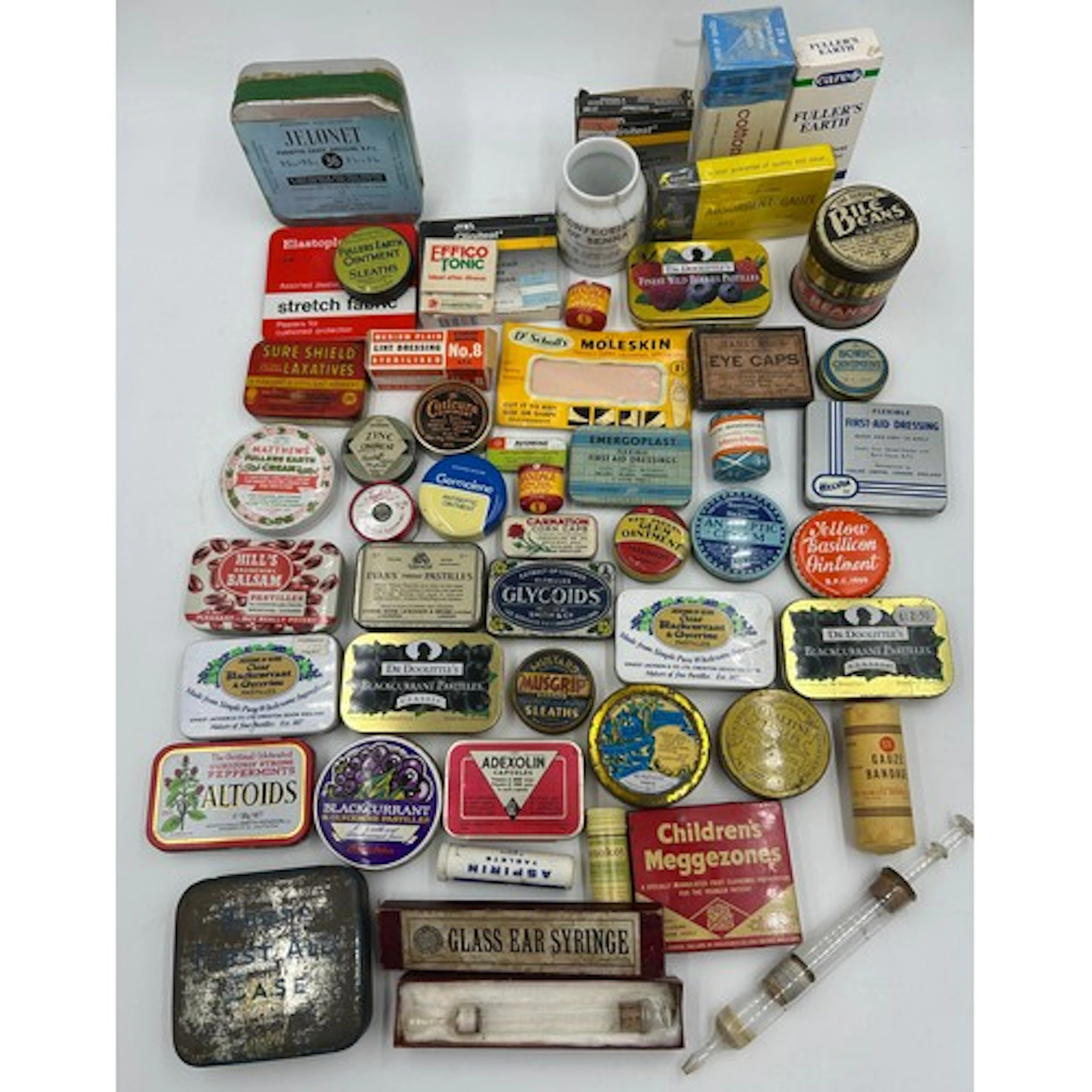 A collection of advertising tins and pharmaceutical products...