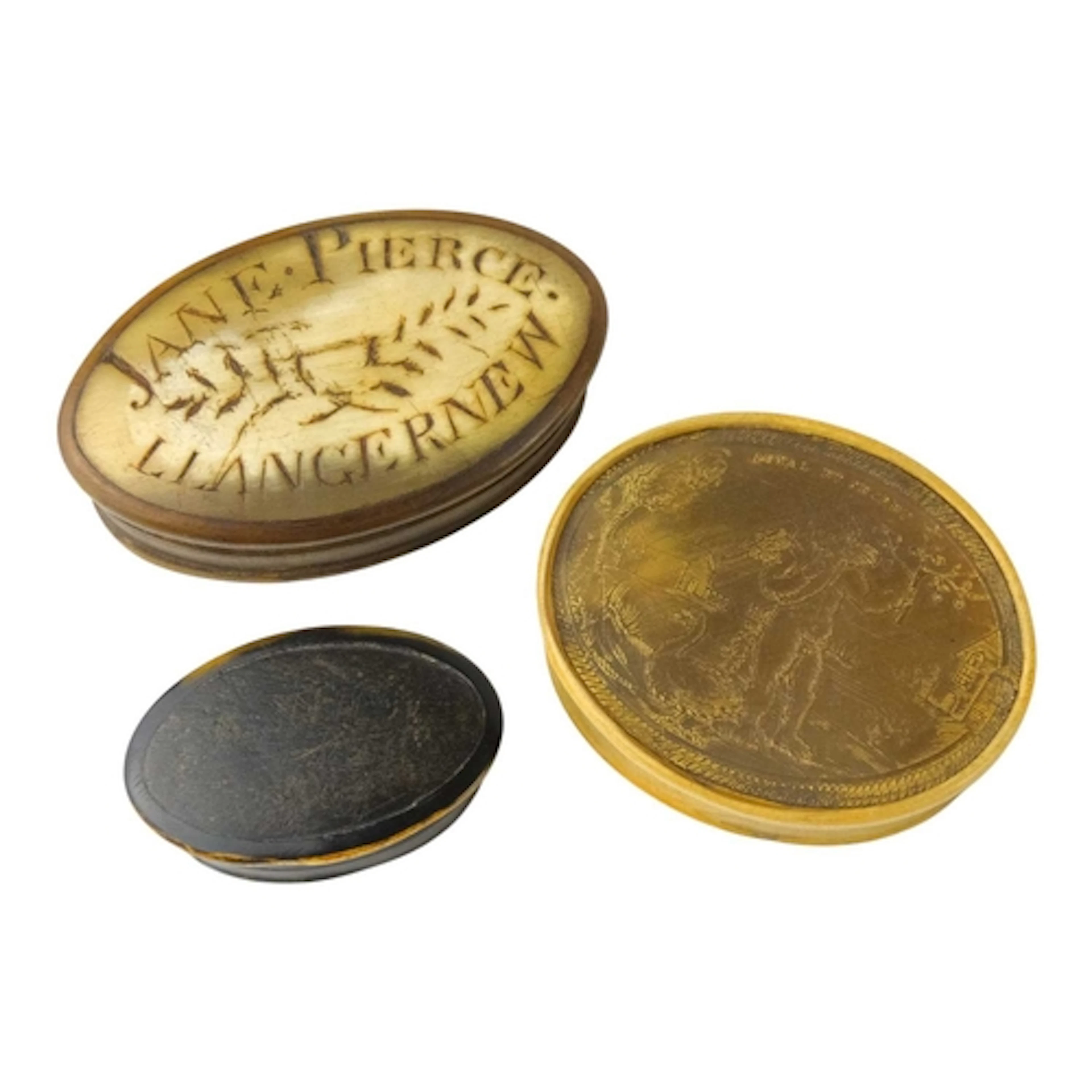 Three 19th century oval horn snuff boxes. One with a pressed...