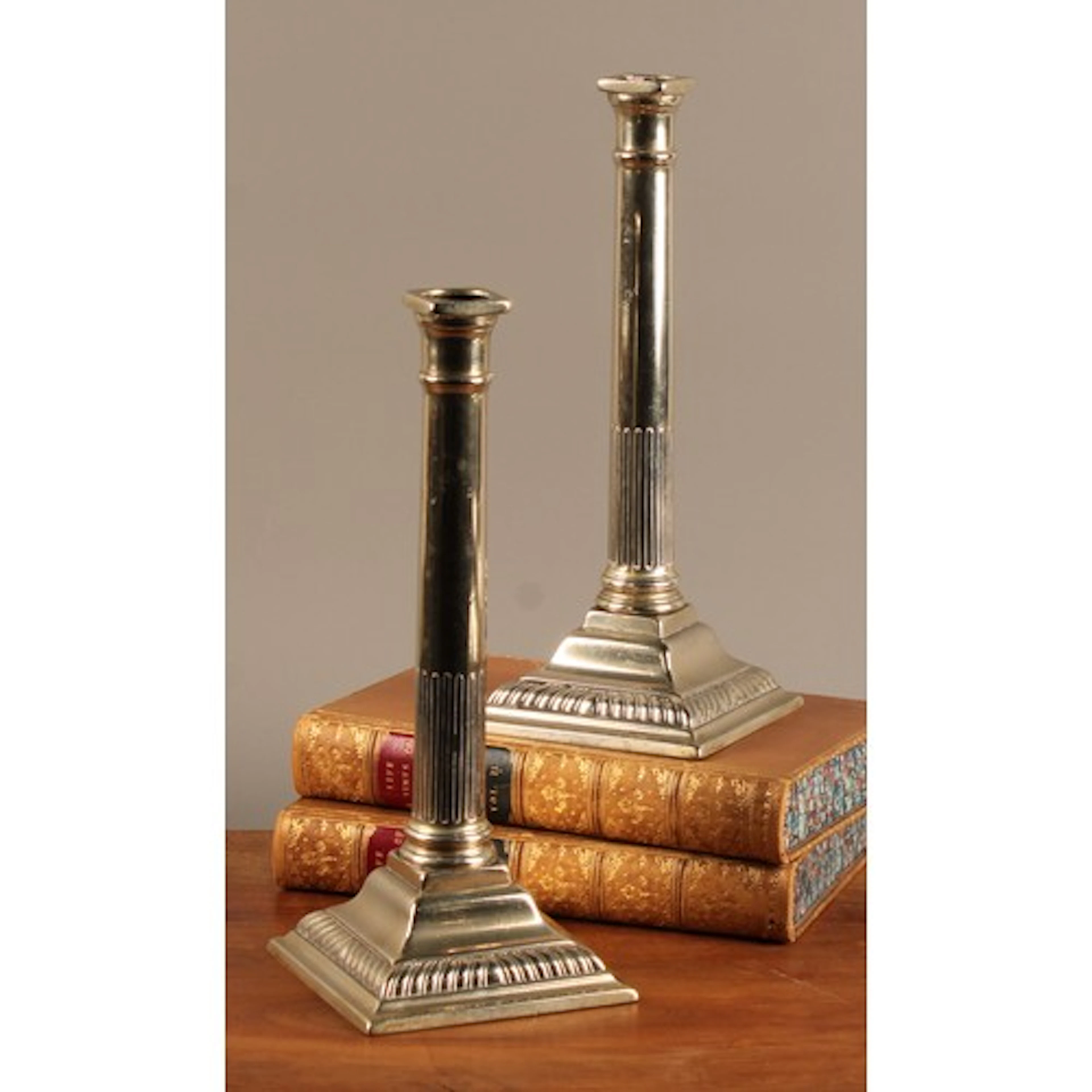 A pair of George III paktong stop-fluted table candlesticks,...