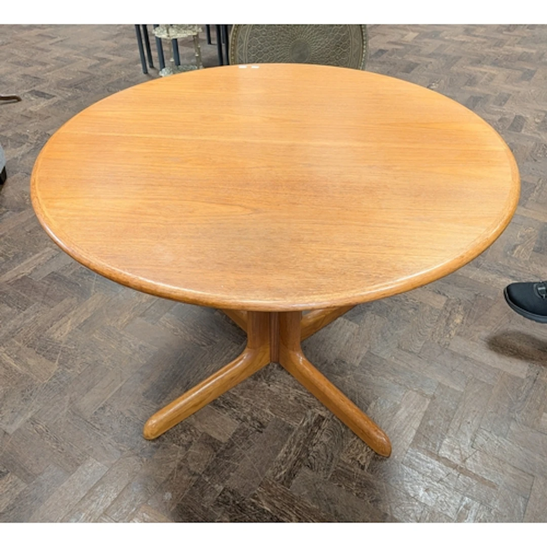 A circular Danish teak pillar dining room table with an extr...