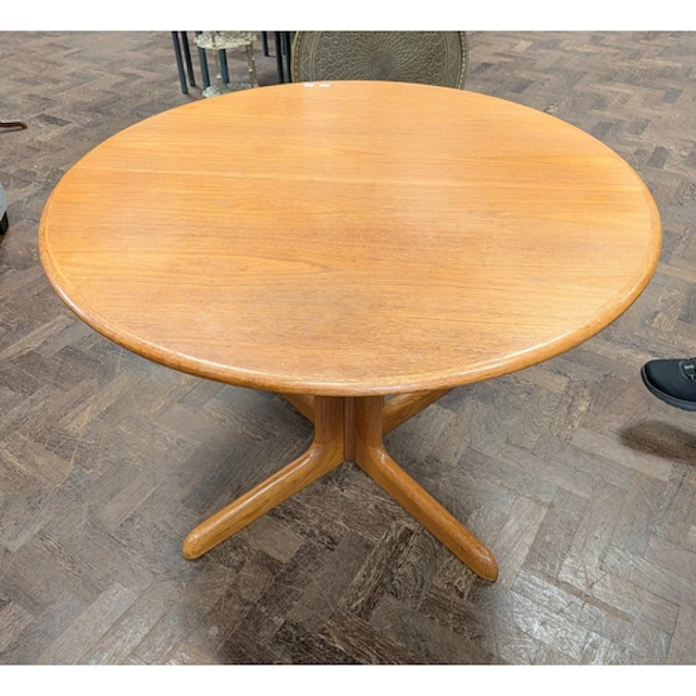 A circular Danish teak pillar dining room table with an extr...