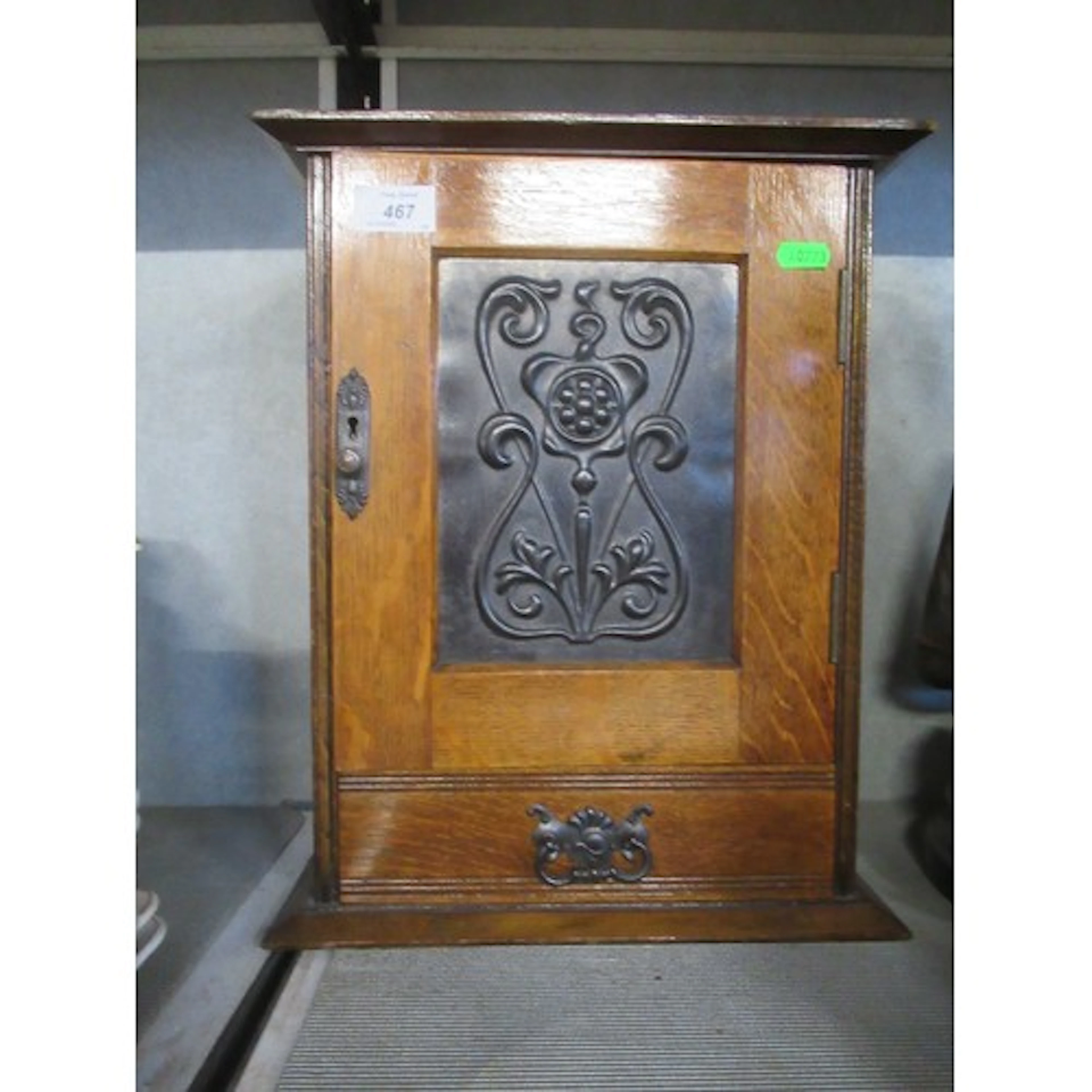 An Edwardian oak Smokes cabinet with Art Nouveau motiff