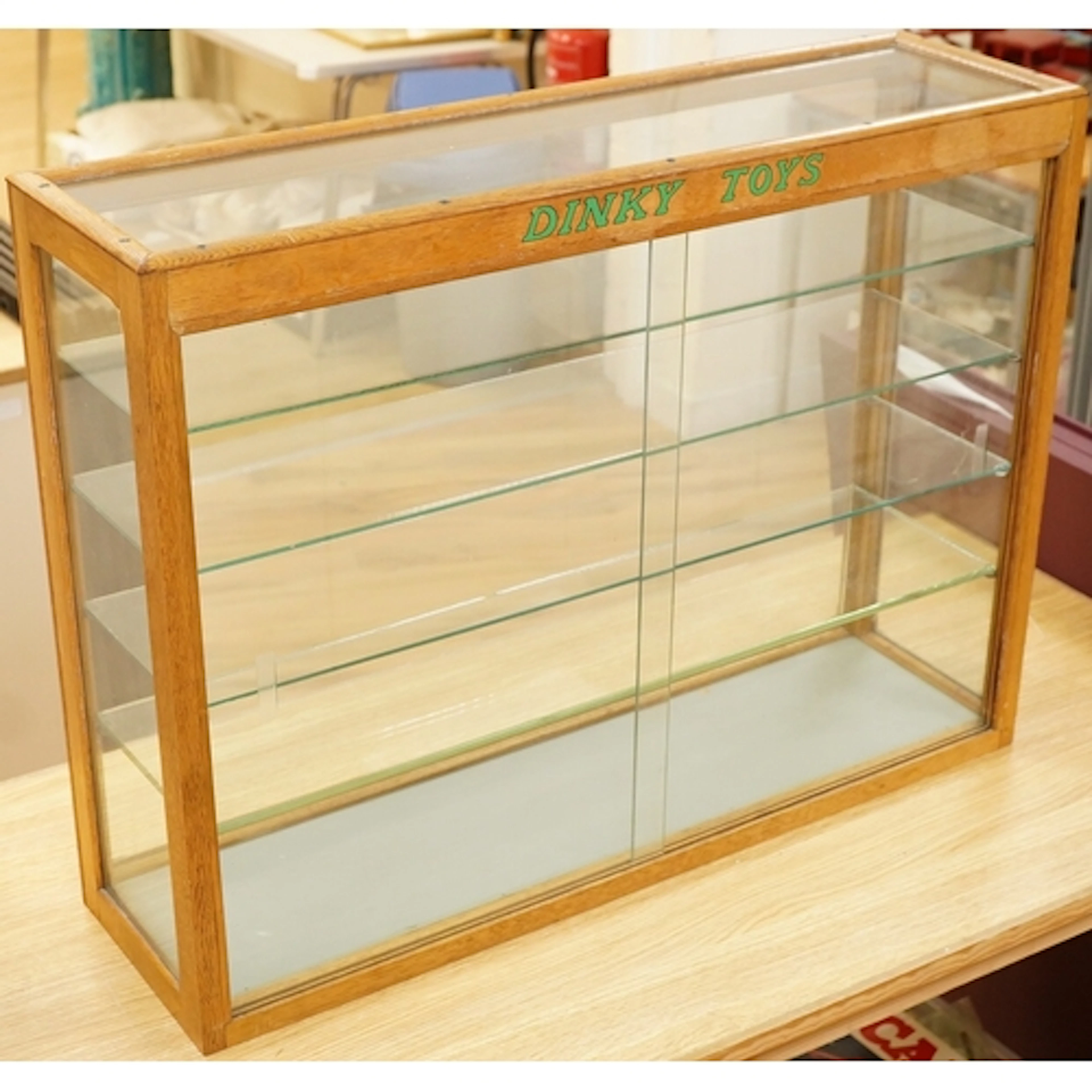 A Dinky Toys glazed oak shop counter retail display cabinet,...