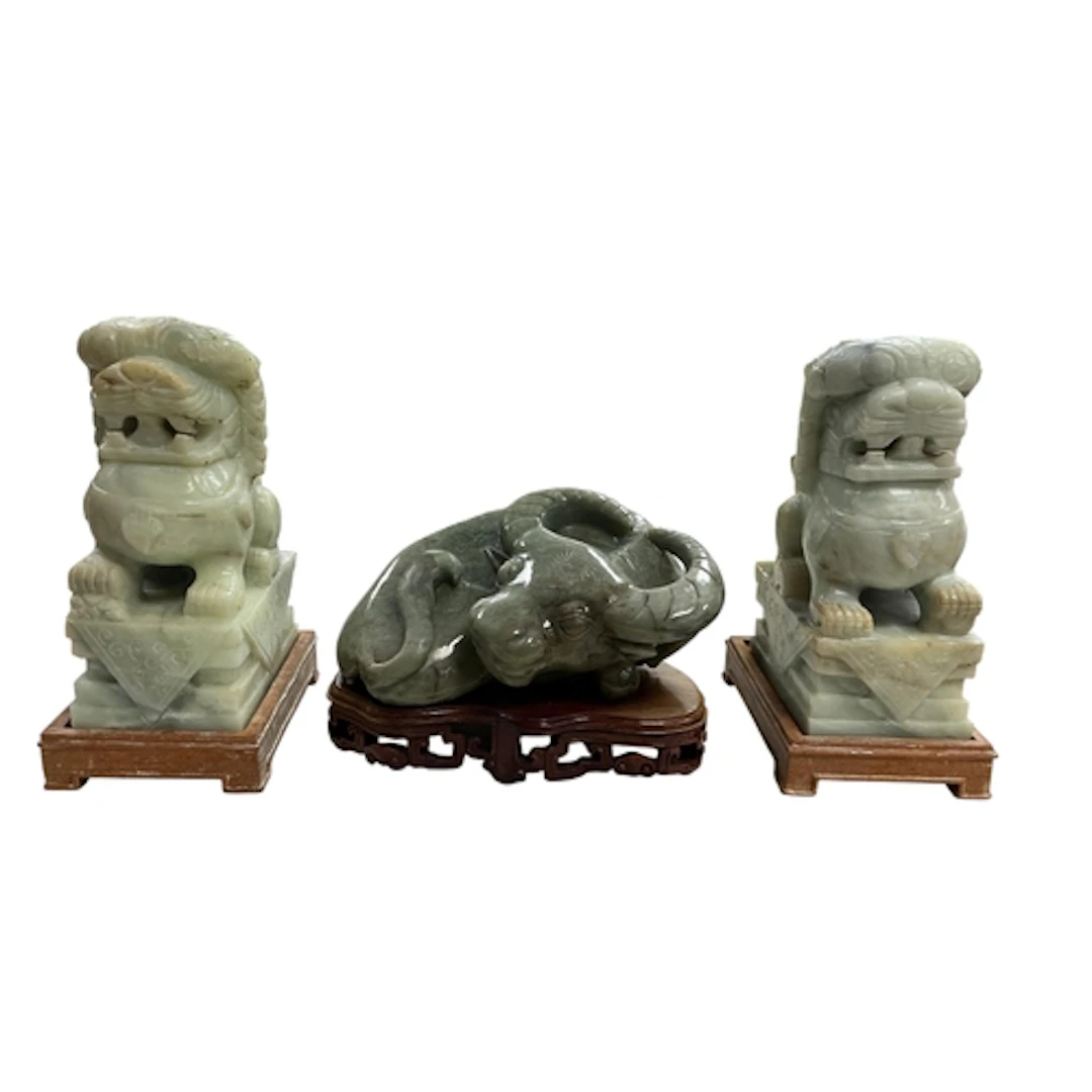 A pair of large Chinese jade lion-dogs and a buffalo all on ...