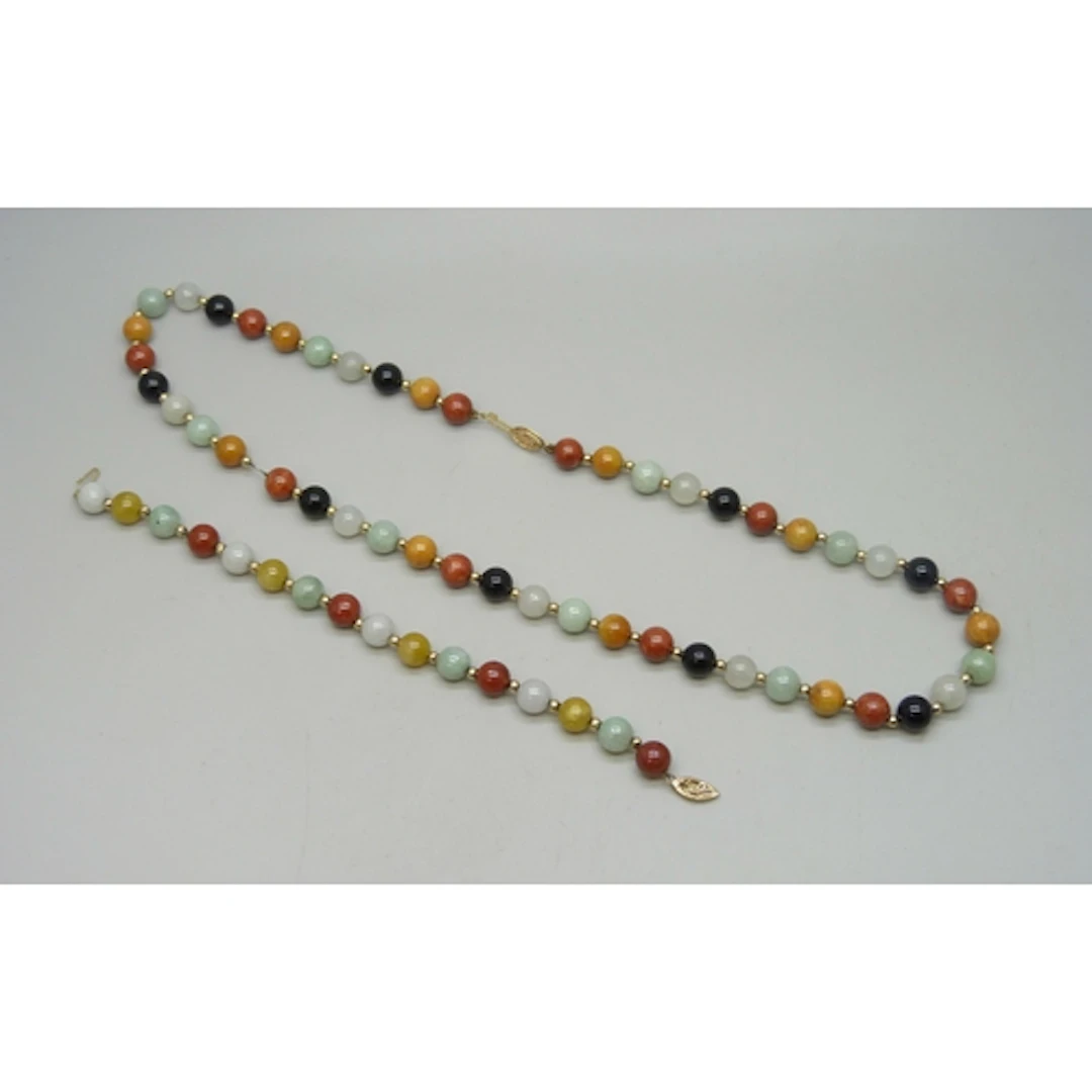 A 14ct gold mounted jade, onyx and other gemstone necklace a...