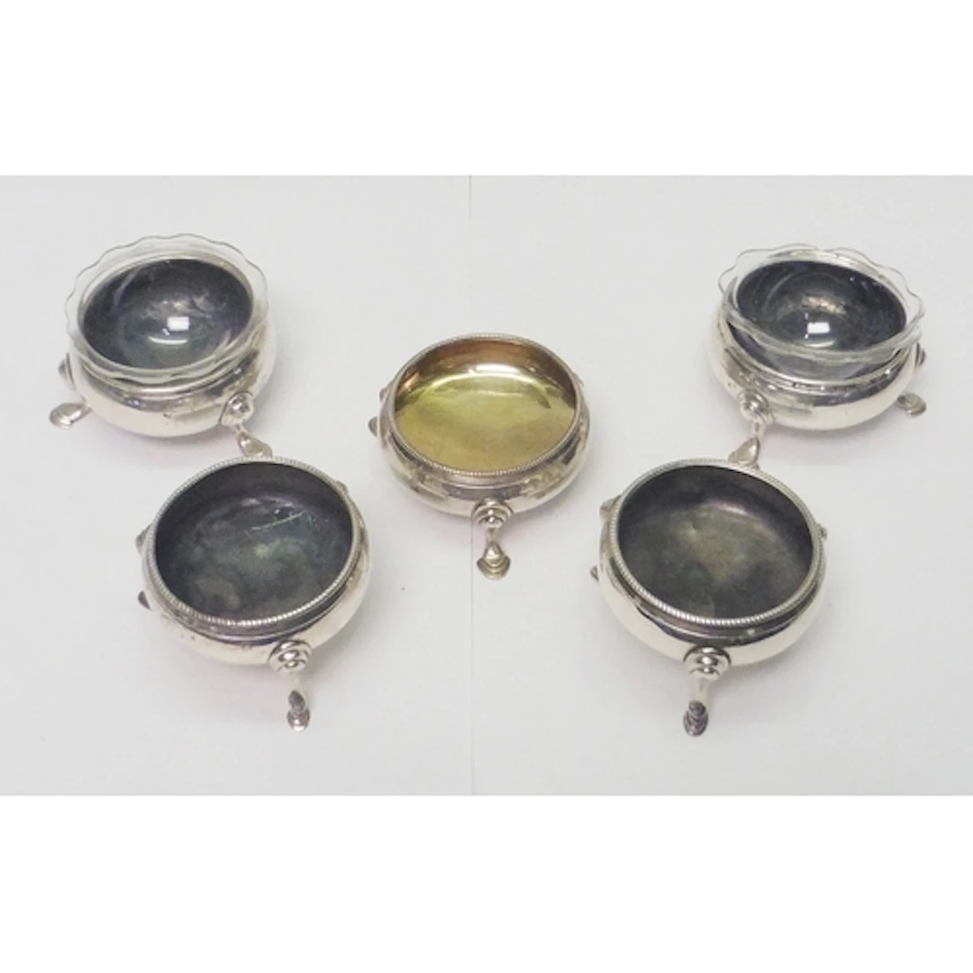 Five similar Georgian 18th cent silver cauldron salts: a pai...