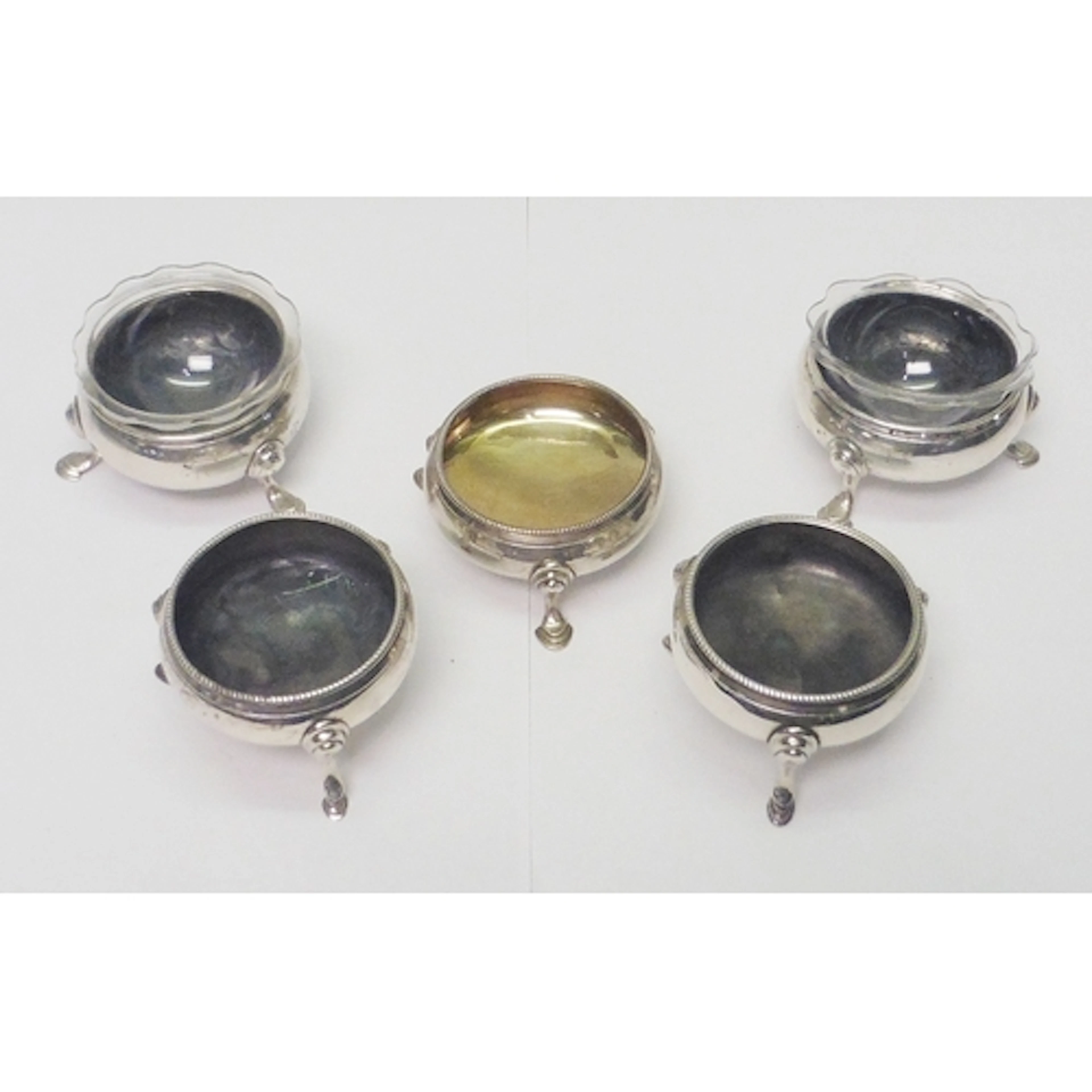 Five similar Georgian 18th cent silver cauldron salts: a pai...