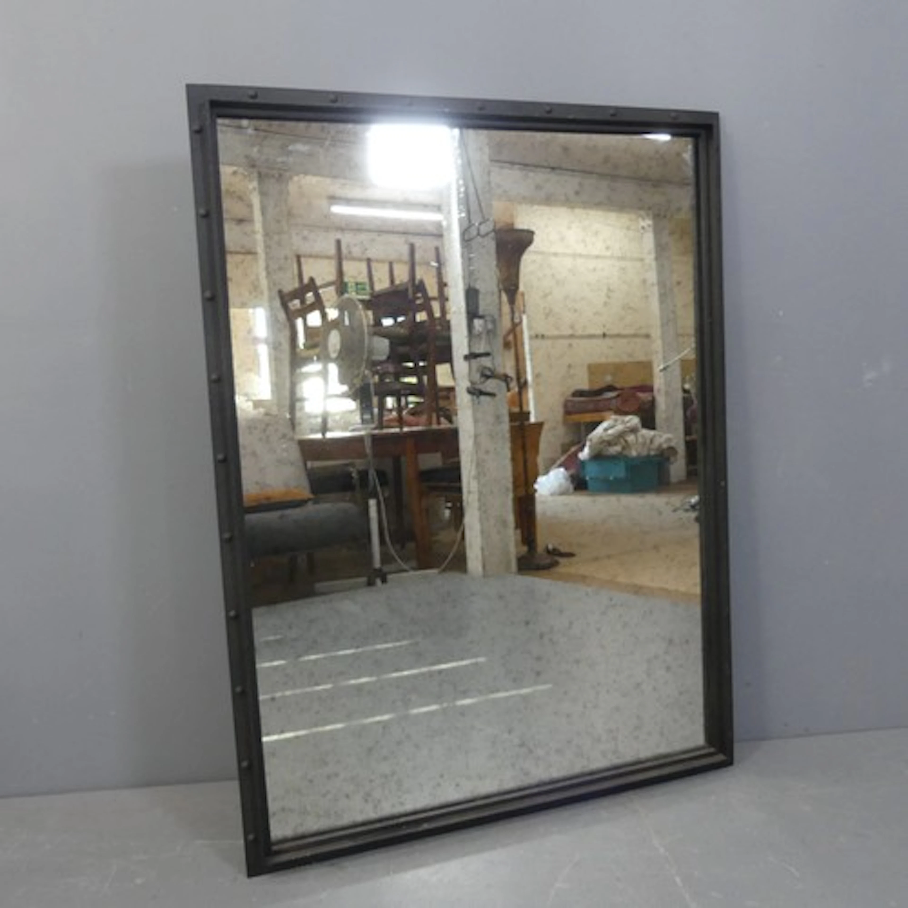 A contemporary rectangular wall mirror with painted metal in...