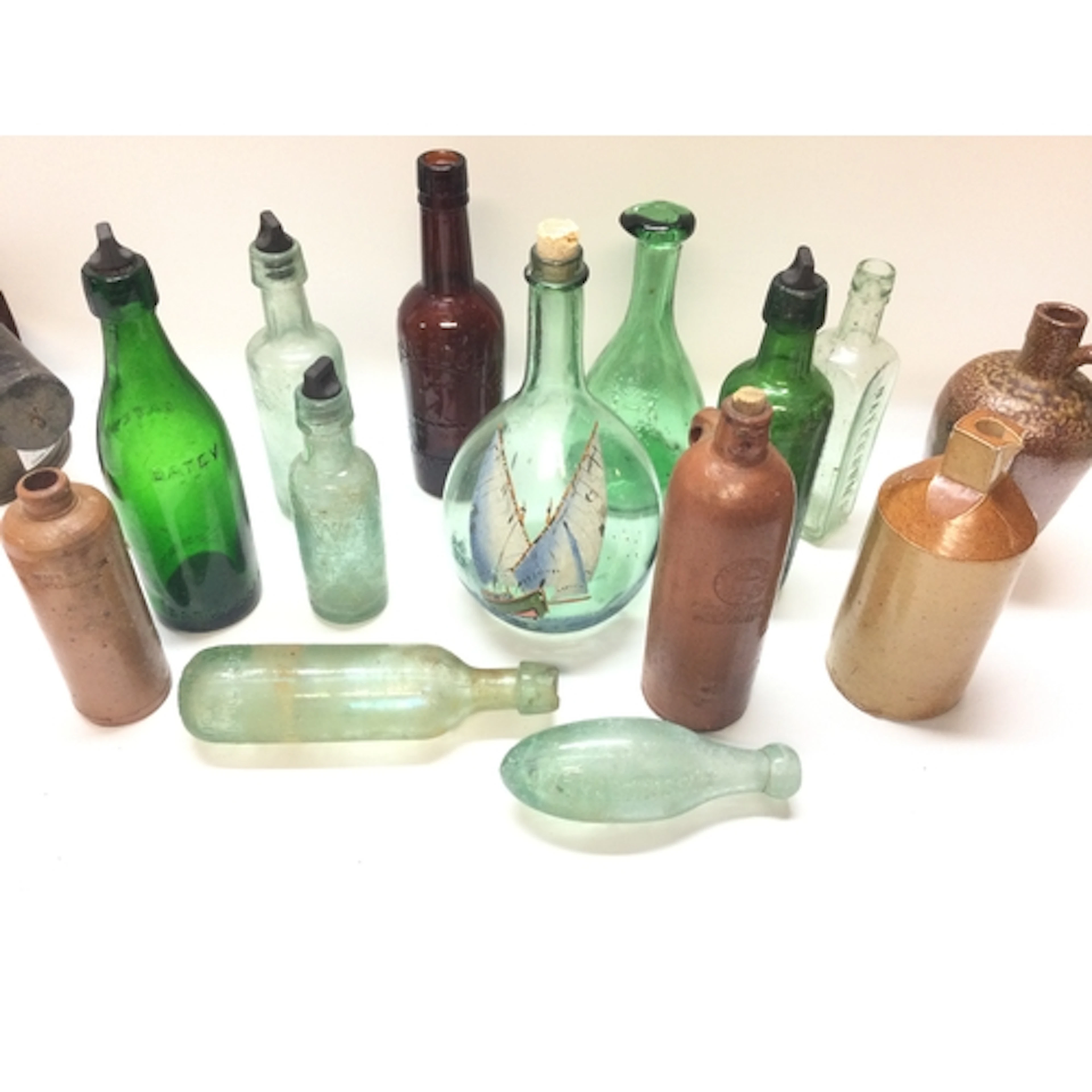 Collection of glassware and stoneware bottles