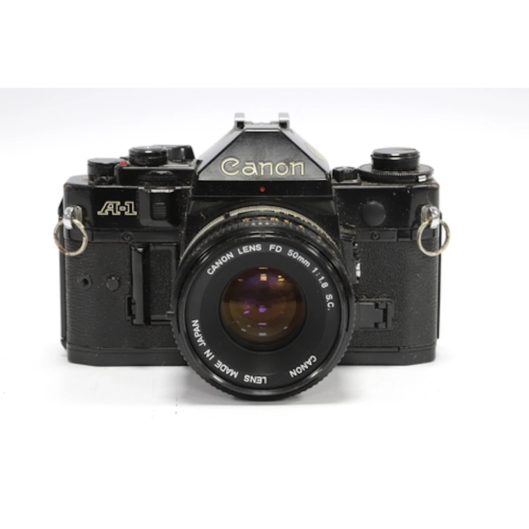 Canon A-1 35mm SLR Film Camera with attached Canin FD 50mm f...