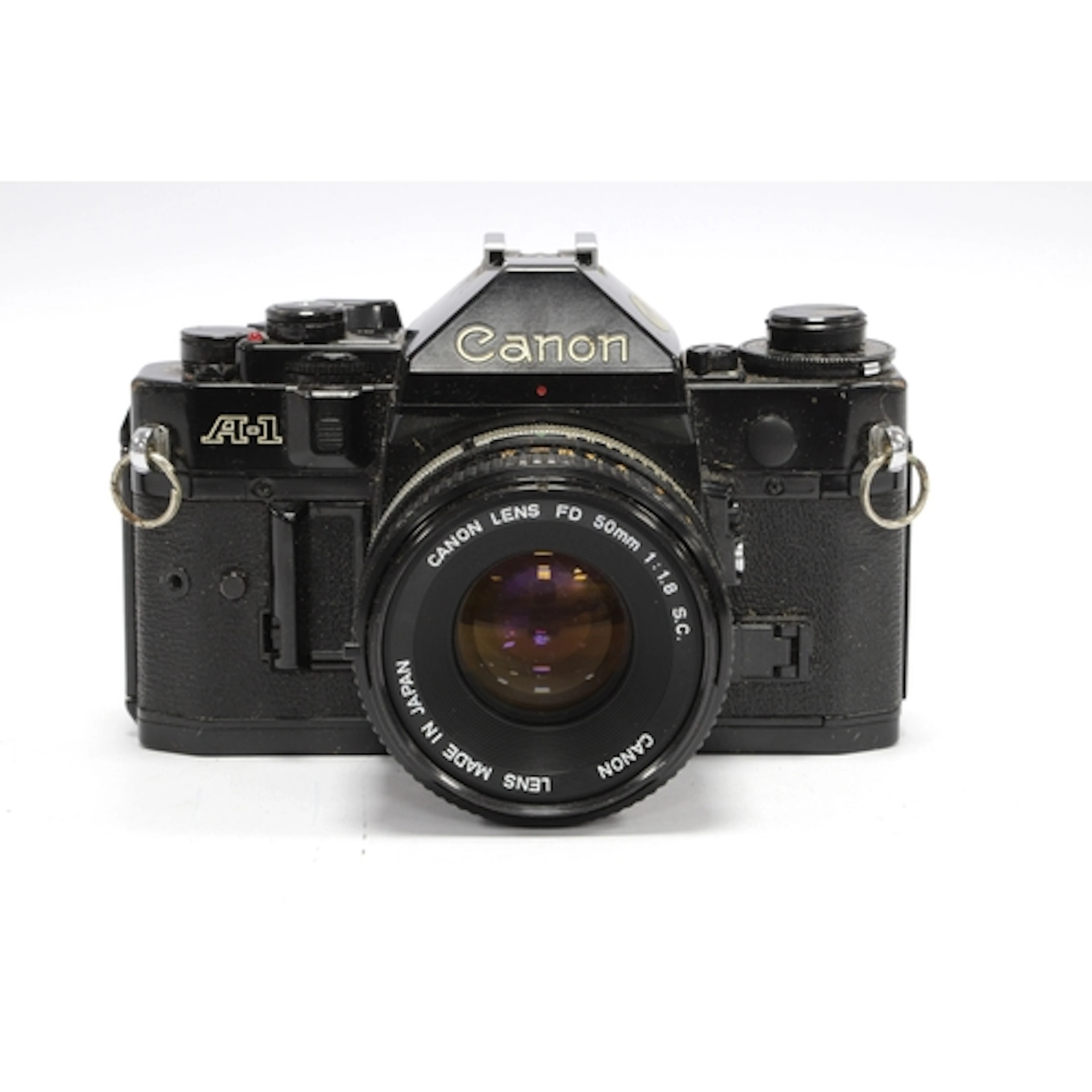 Canon A-1 35mm SLR Film Camera with attached Canin FD 50mm f...