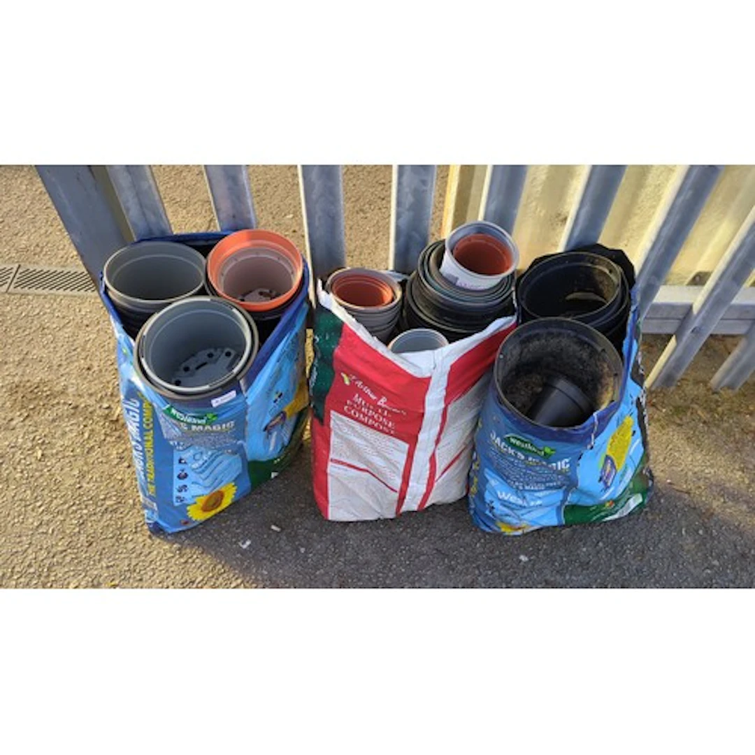 A quantity of plastic nursery pots in assorted sizes and col...