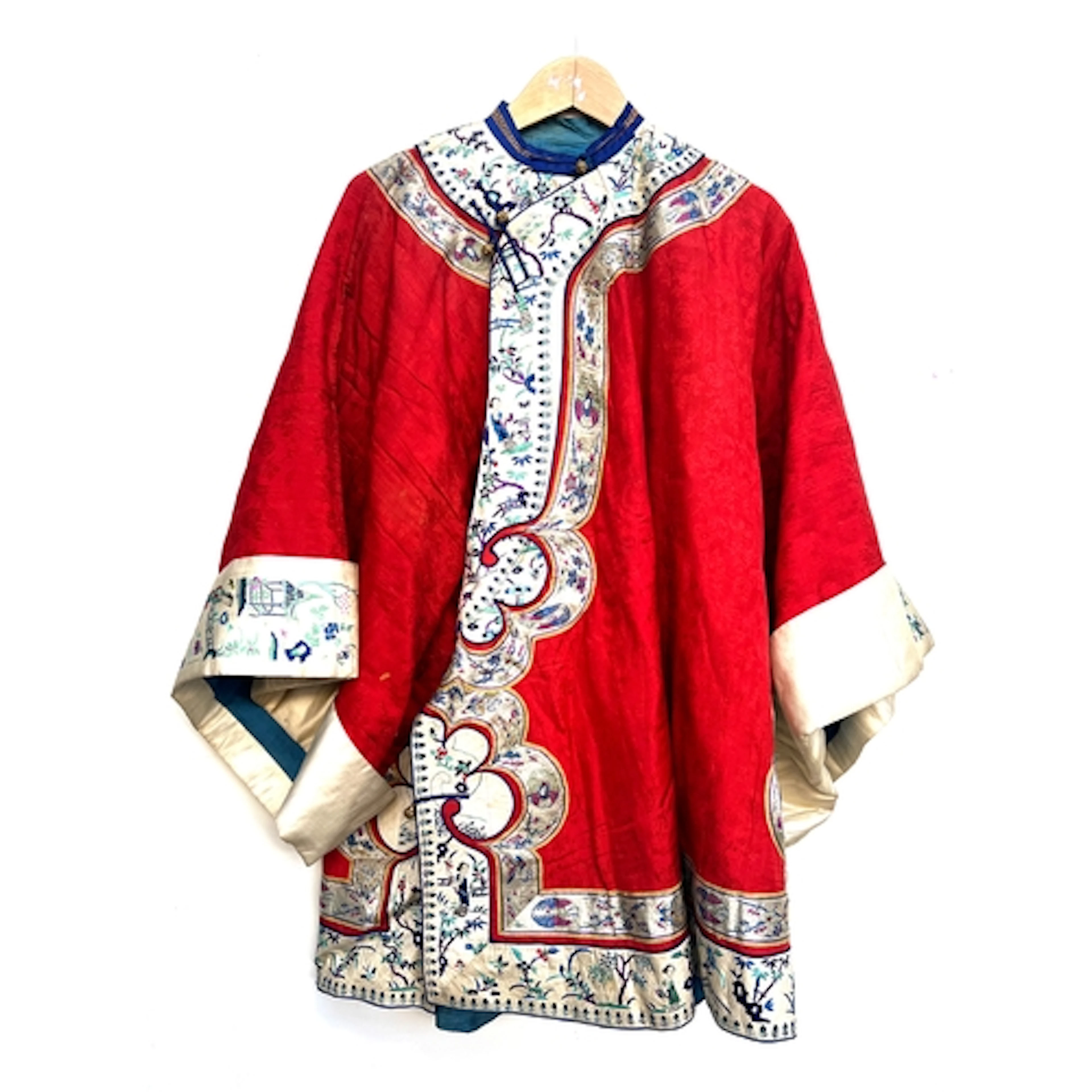 An antique Chinese quilted silk robe, red damask silk with w...