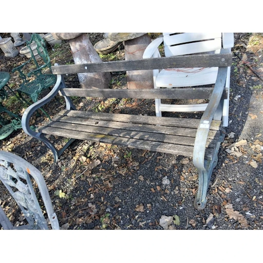 AN EARLY 20th CENTURY CAST IRON ENDED GARDEN BENCH with dist...