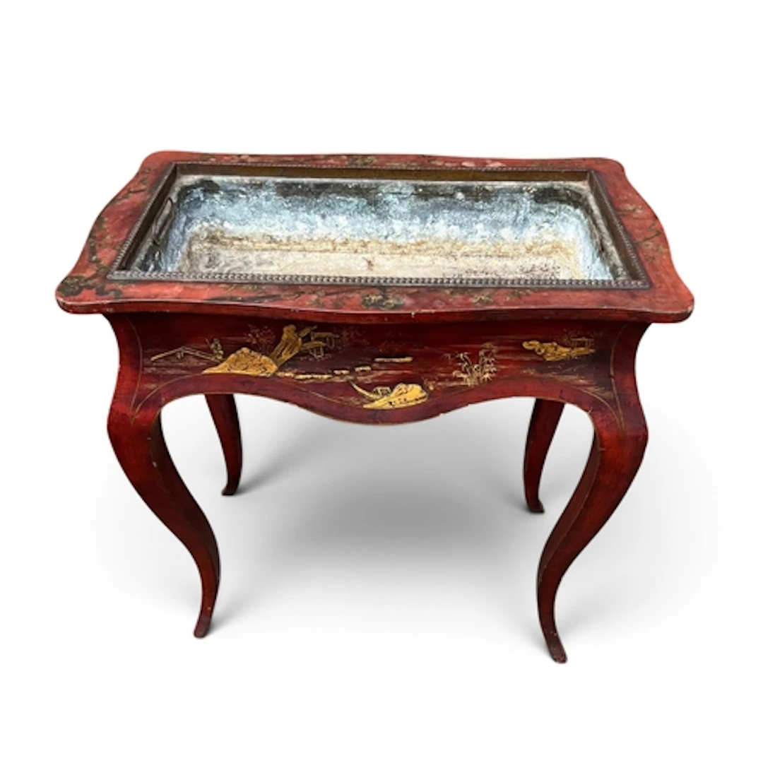 A CHINOISERIE LACQUERED RED AND GILT JARDINIERE TABLE, IN MI...