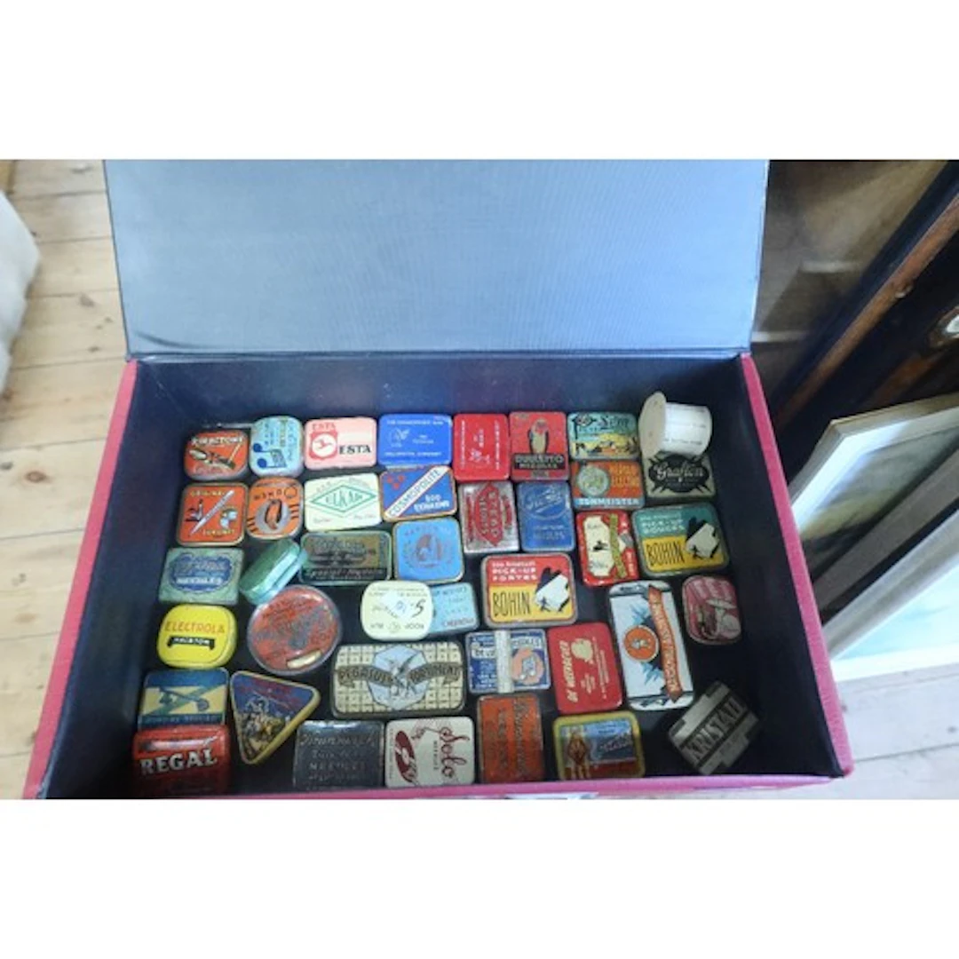 A box of vintage gramophone needle tins