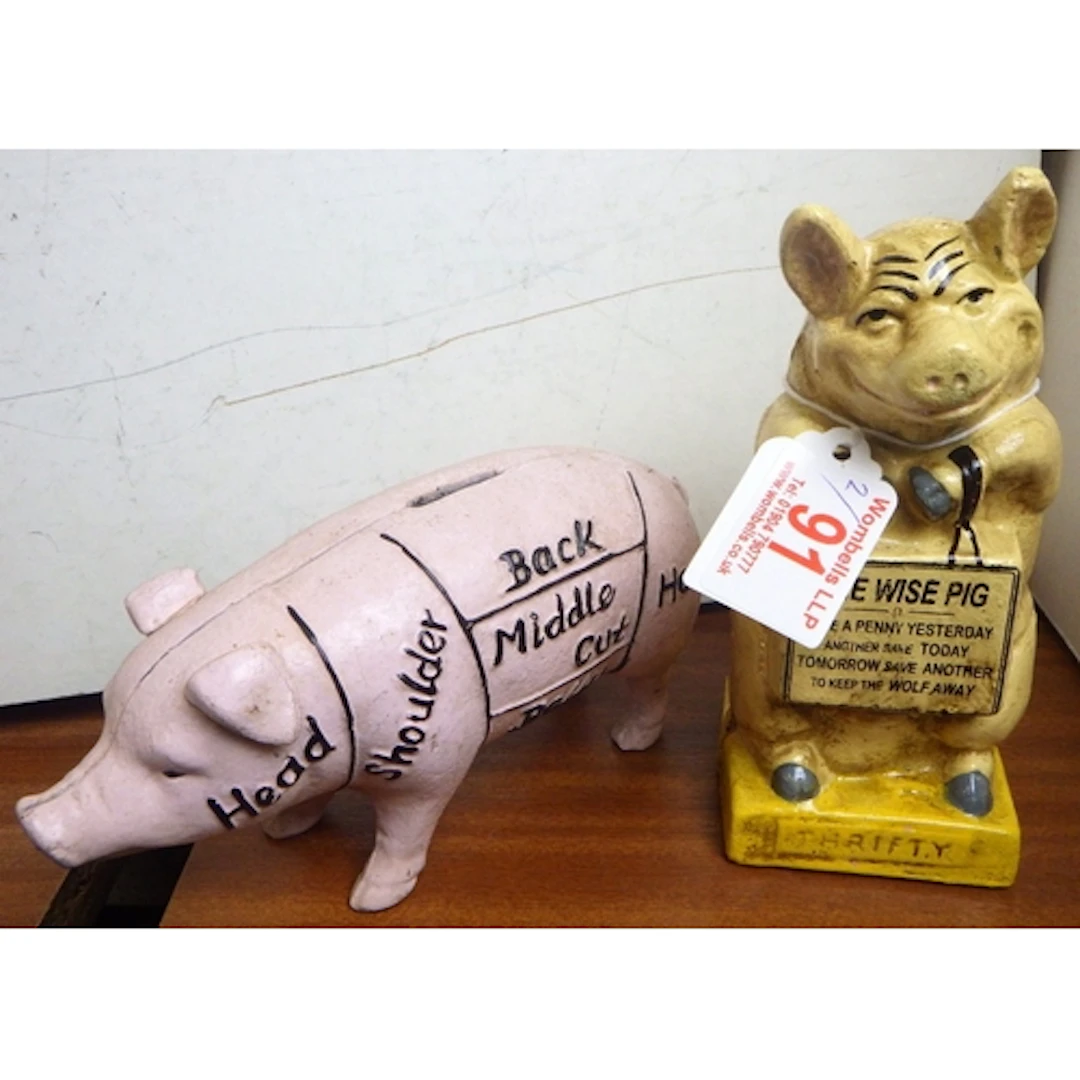 Two cast money pigs, tallest 16cm