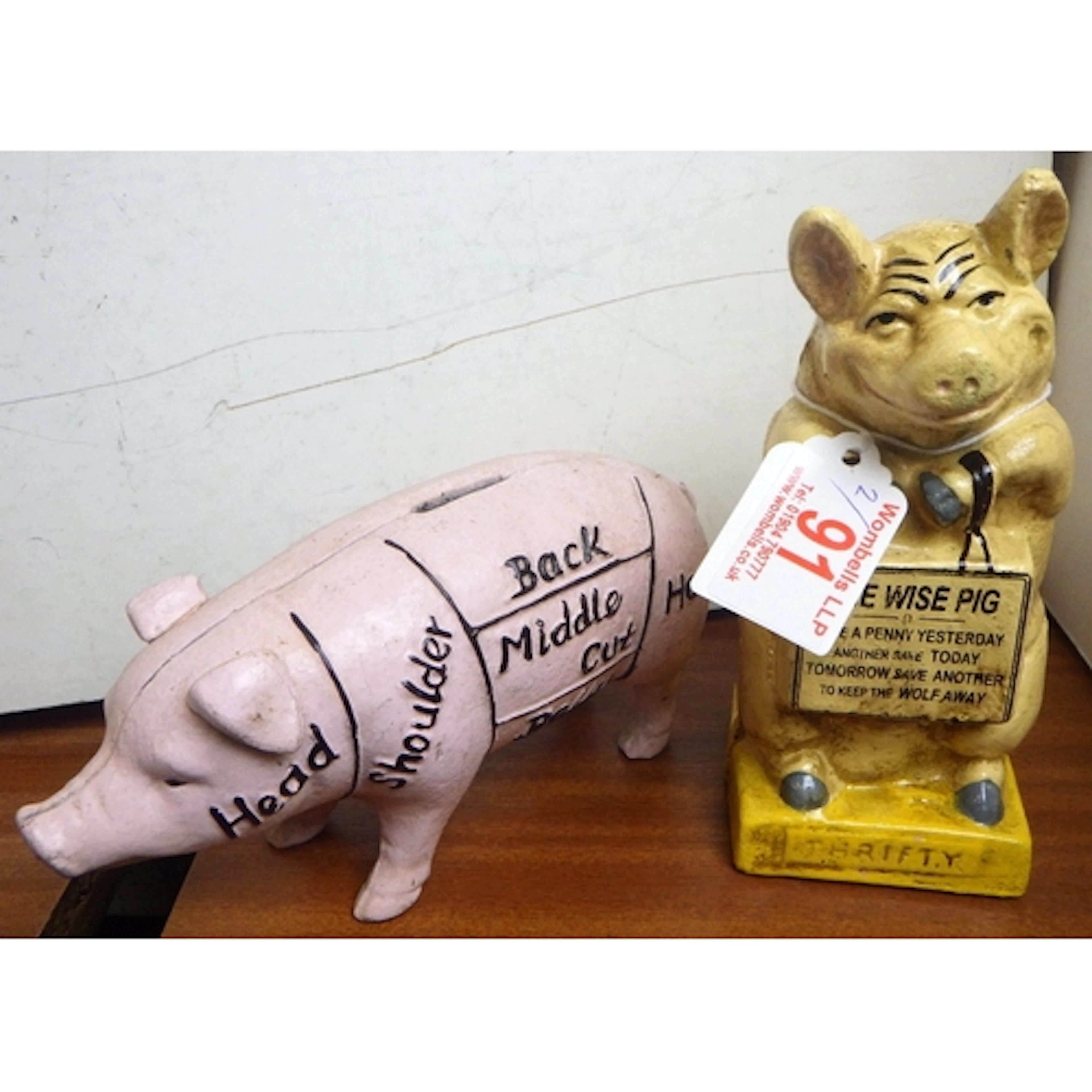 Two cast money pigs, tallest 16cm